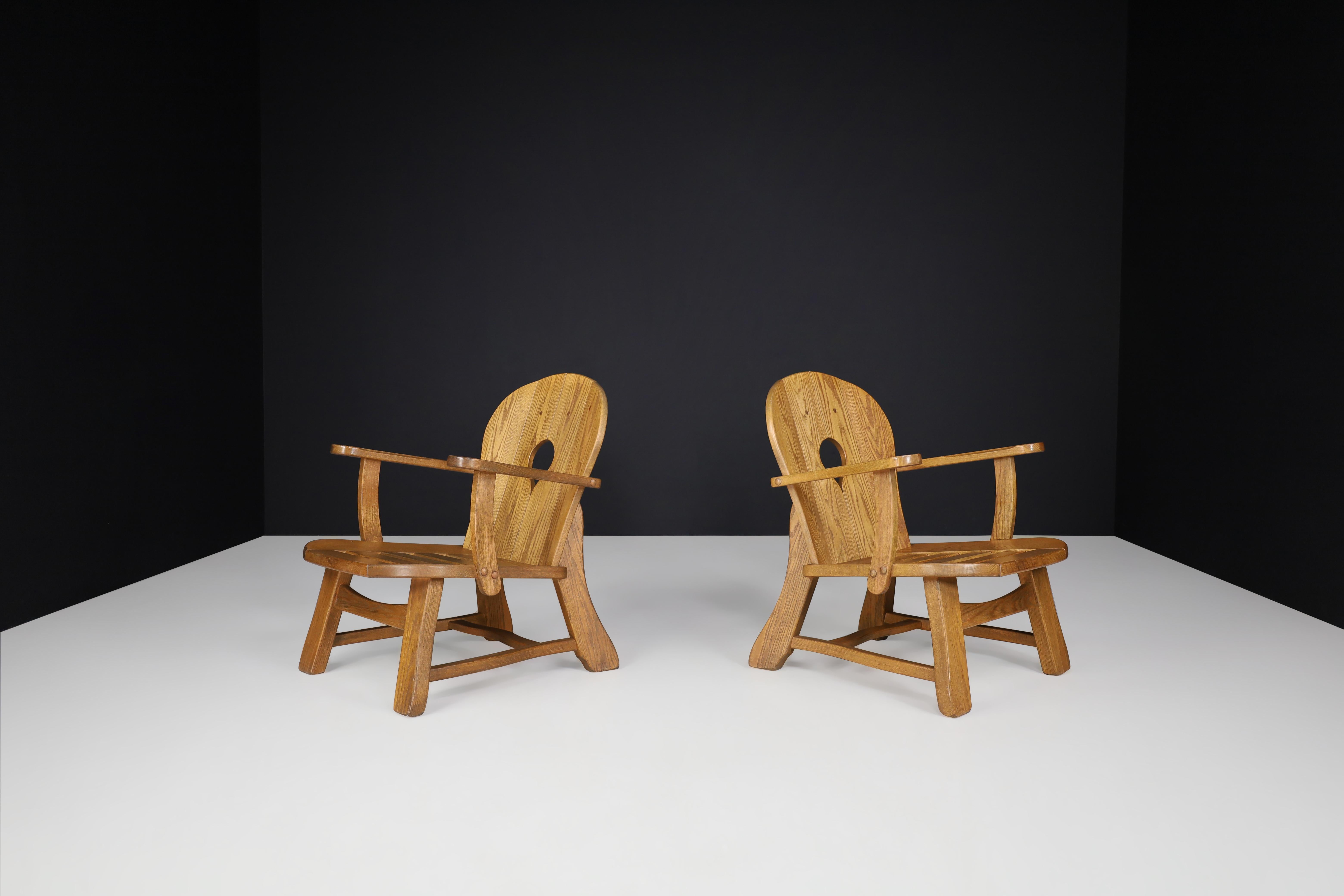 Set of two sculptural lounge chairs in oak, France, 1960s.

Set of two sculptural armchairs, these chairs are made of French oak and sculpturally crafted by hand in France in the 1960s. The craftsmanship is still visible; they are made of solid