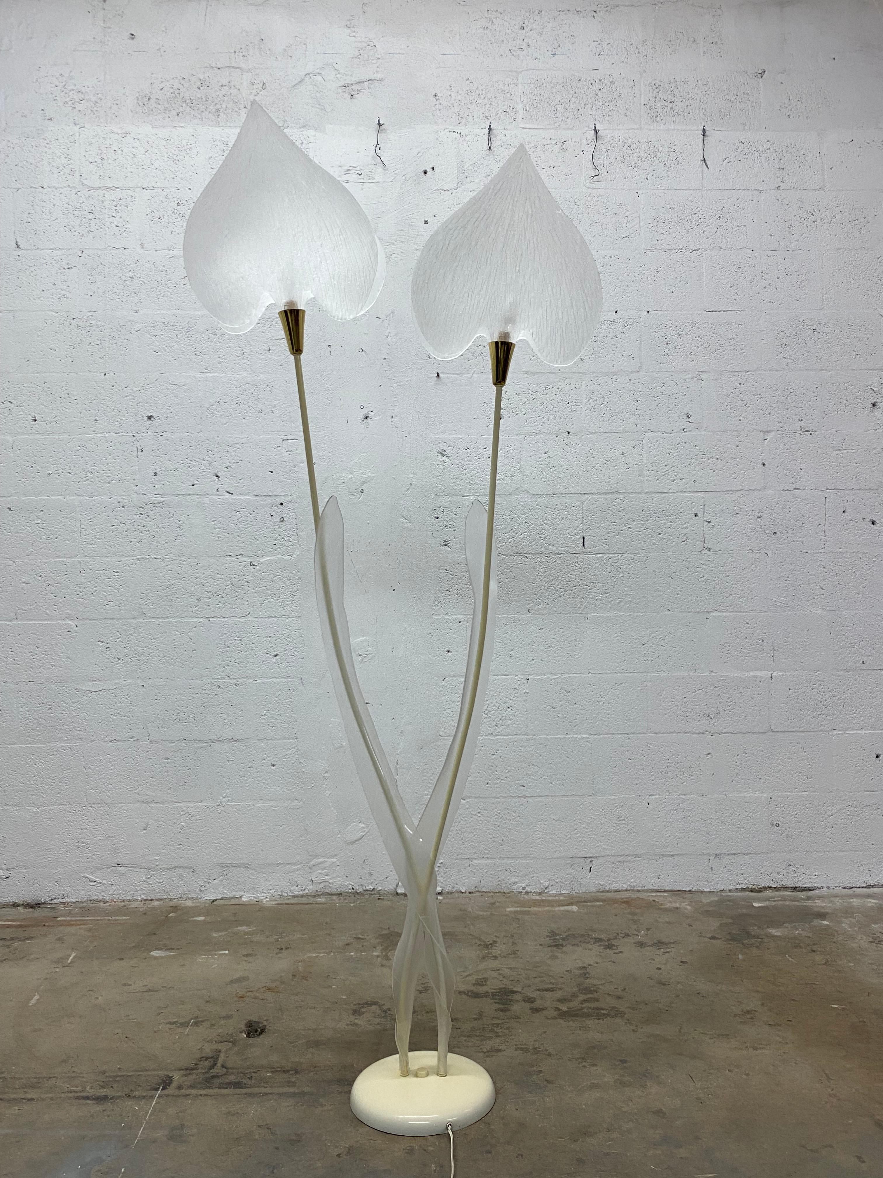 Mid-century floor lamp with opaque lucite leaf shades attached to brass sockets and connected to long, thin bent rods to resemble a tree or plant.