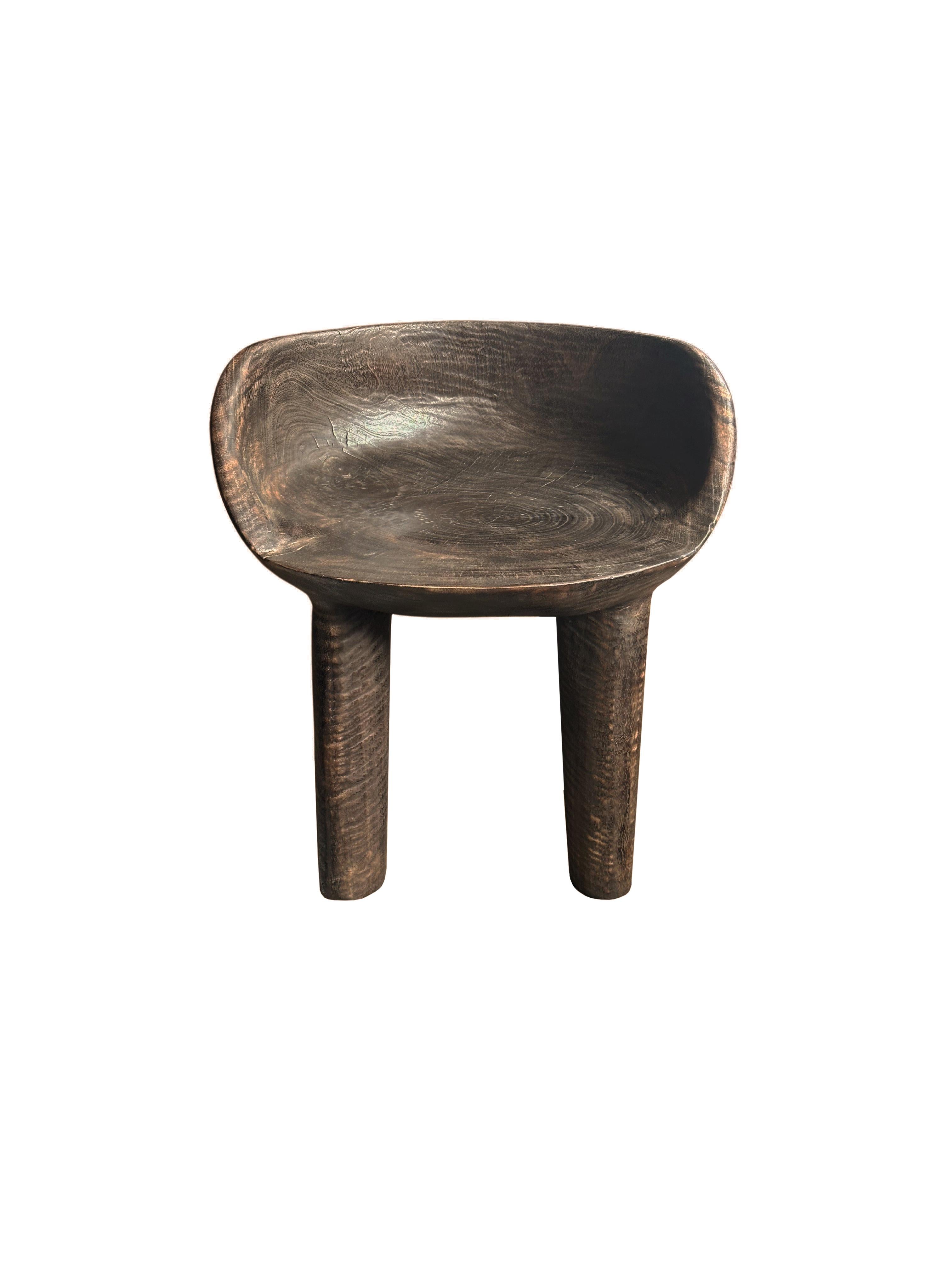 This wonderfully sculptural chair was crafted from a single block of mango wood. The chair sits on 4 slender legs. Its neutral pigment makes it perfect for any space. A uniquely sculptural and versatile piece certain to invoke conversation. This
