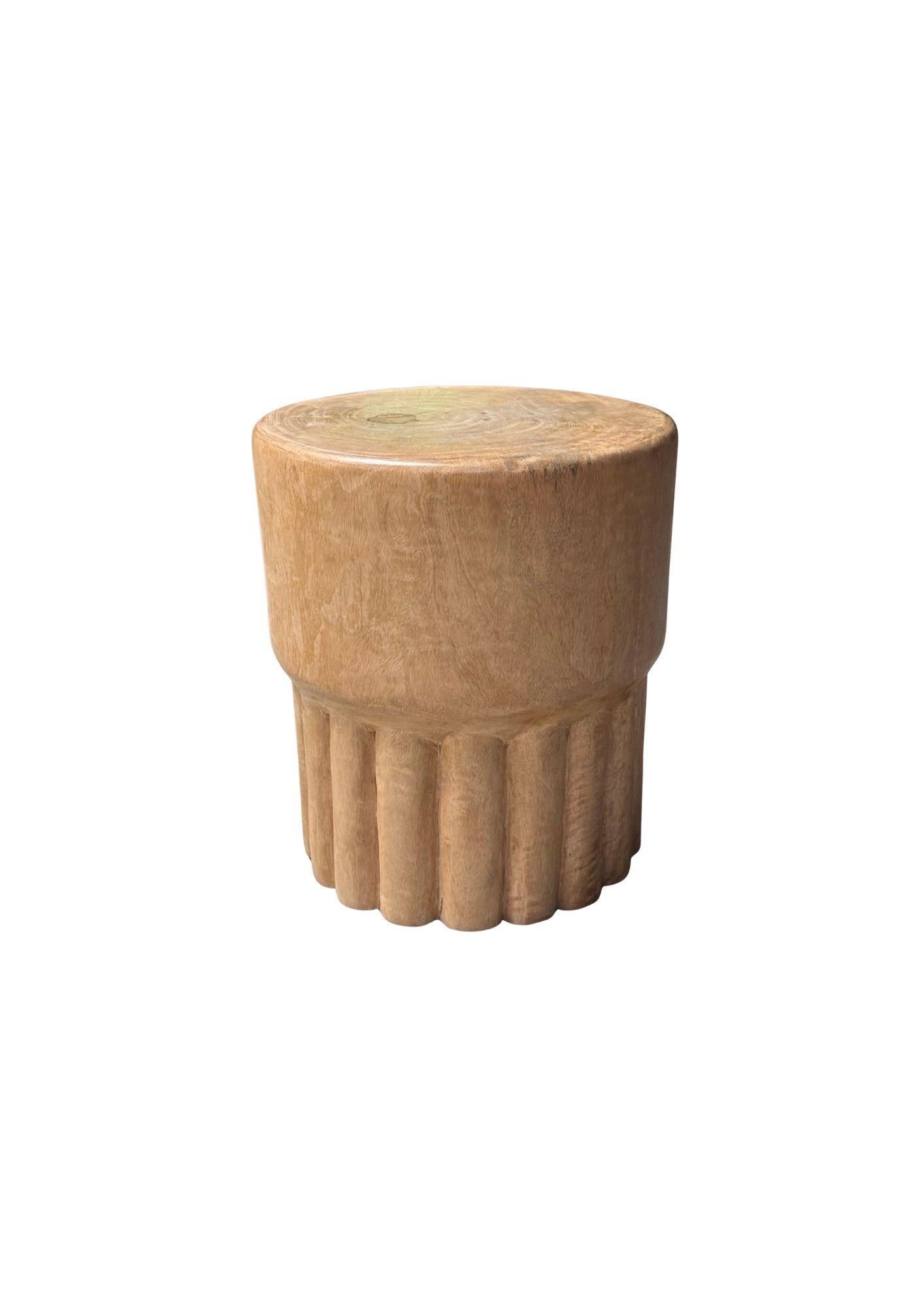 This sculptural mango wood side table is a masterful fusion of art and functionality, showcasing the natural beauty of wood in its most organic form. Crafted from premium mango wood, the table features stunning wood textures, with rich grain