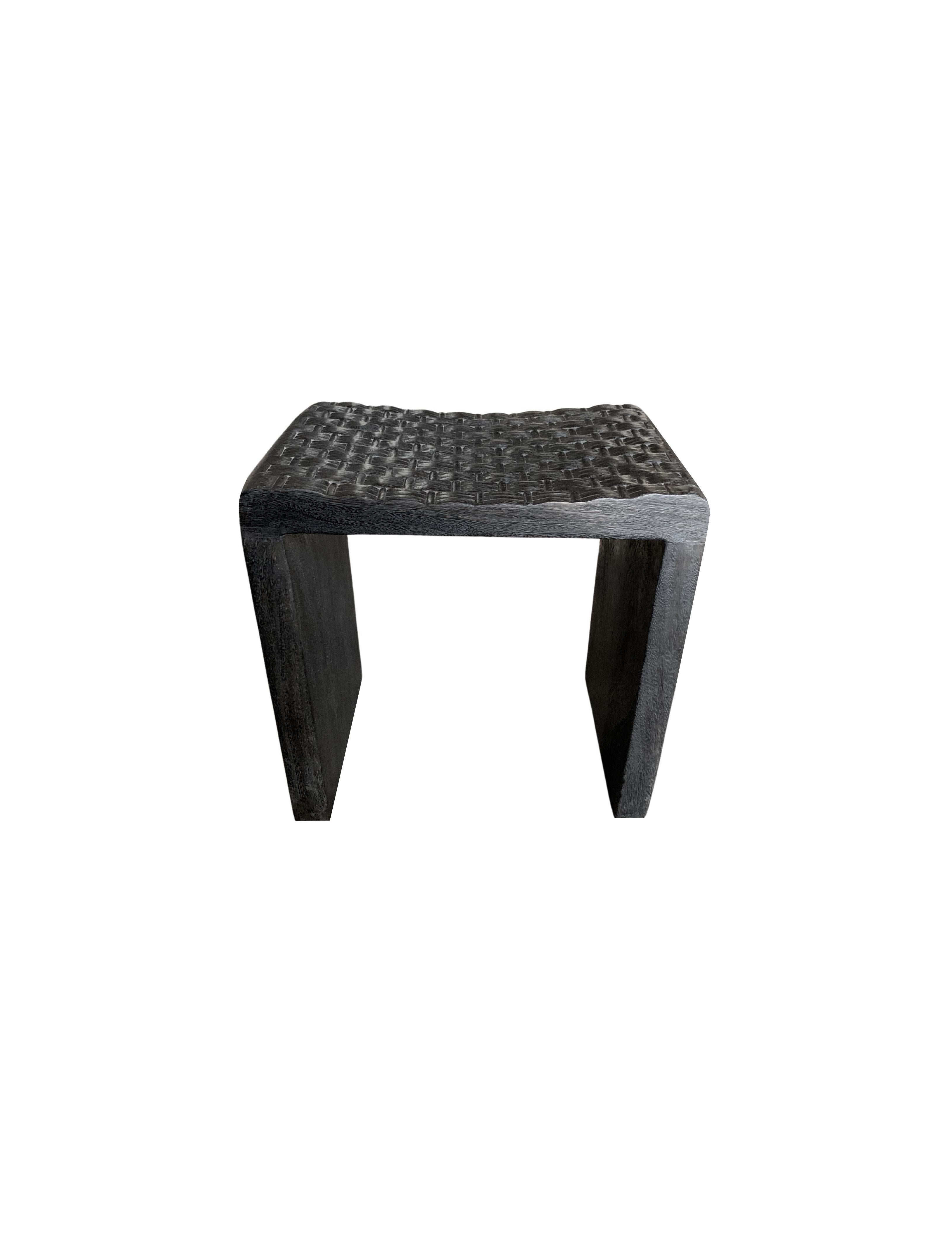 This wonderfully sculptural stool was crafted using mango wood. Its neutral pigment makes it perfect for any space. A uniquely sculptural and versatile piece. Unique to this chair is the carved seat, which features carved detailing meant to resemble