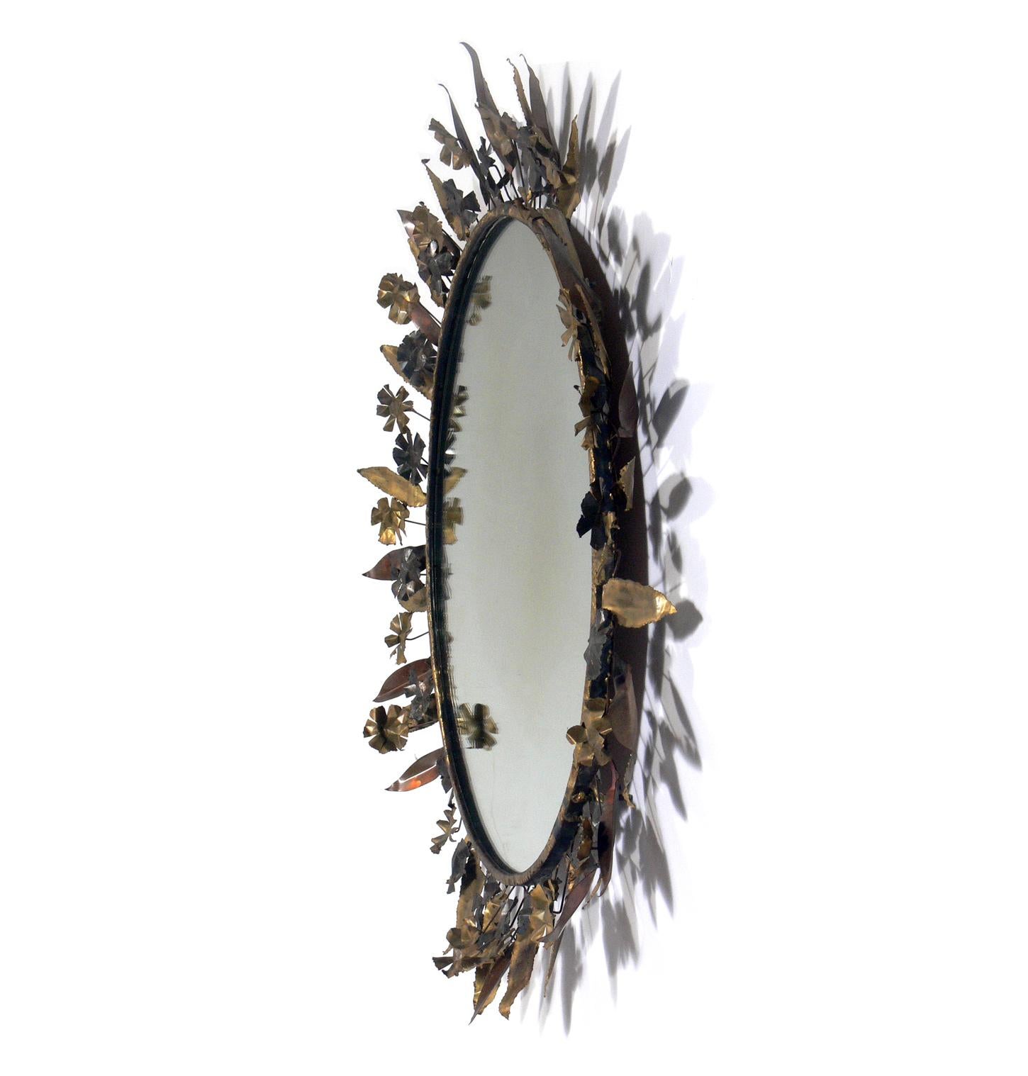 Sculptural metal flowers and leaves mirror, in the manner of Line Vautrin, C. Jere, et al. Probably American, circa 1960s. Retains warm original patina.