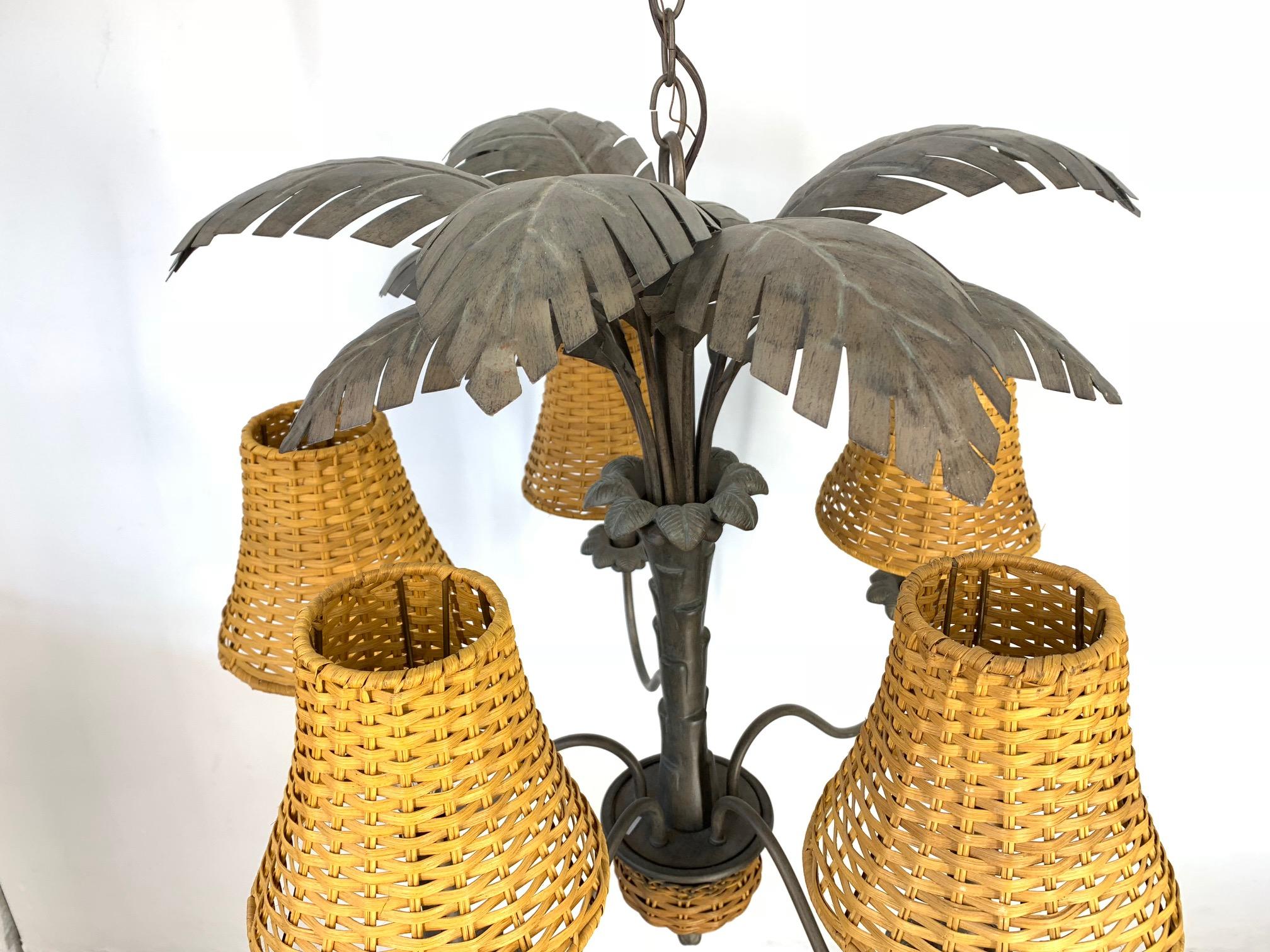 Sculptural midcentury Palm tree chandelier features rattan shades and accents. Includes chain and ceiling cap. Very good vintage condition.