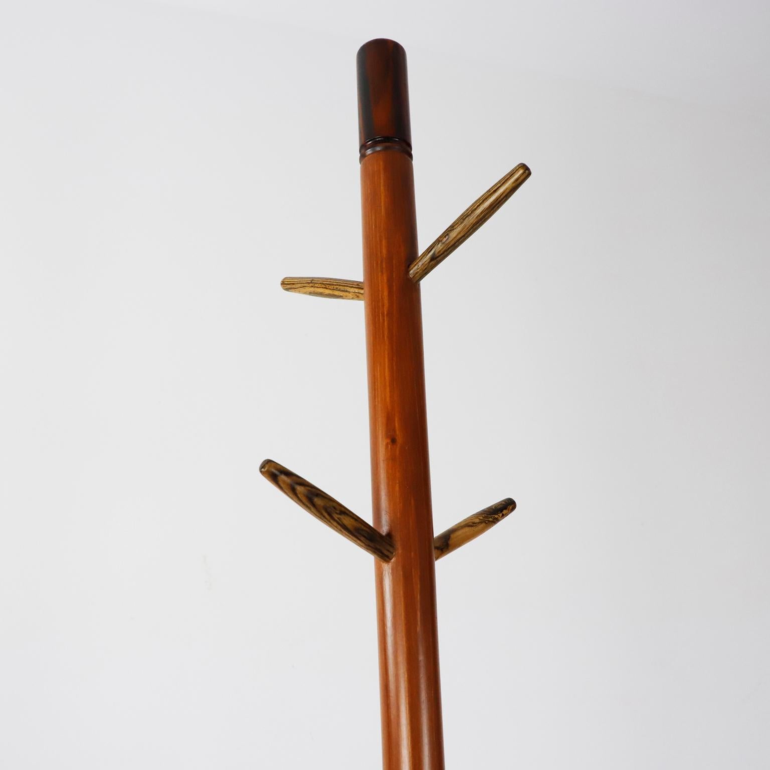 Designed by IRGSA (Industrias Ruíz Galindo), circa 1960. We offer this wonderful Mid-Century Modern coat rack made pine with different exotic woods accents. The coatrack is sculptural enough it can be put in nearly any environment and still hold