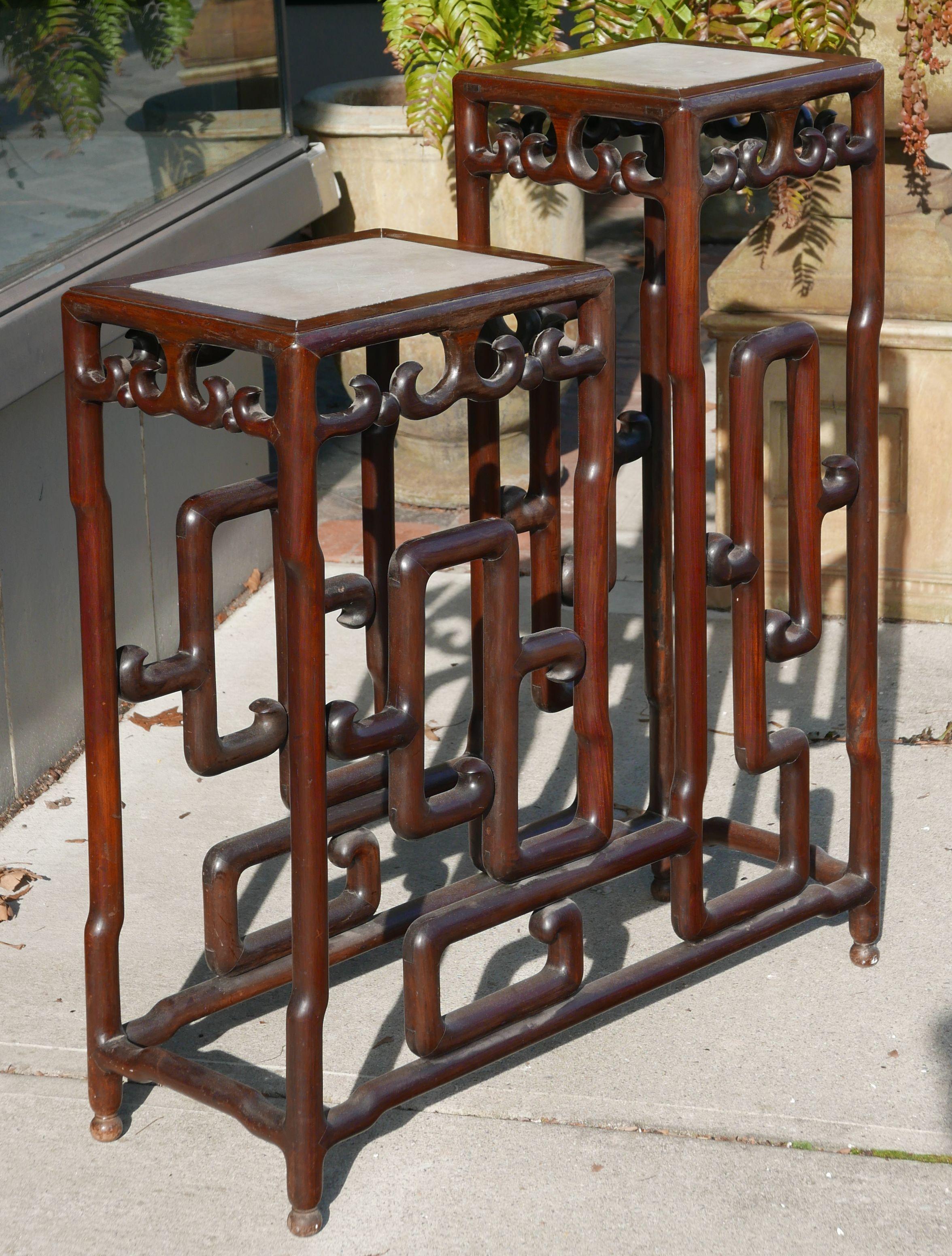 Sculptural rosewood Chinese republic era double pedestal or plant stand with marble tops. Featuring rosewood base with mortise and tenon construction. It's pretty amazing the actual construction of the piece. taller pedestal measures 12