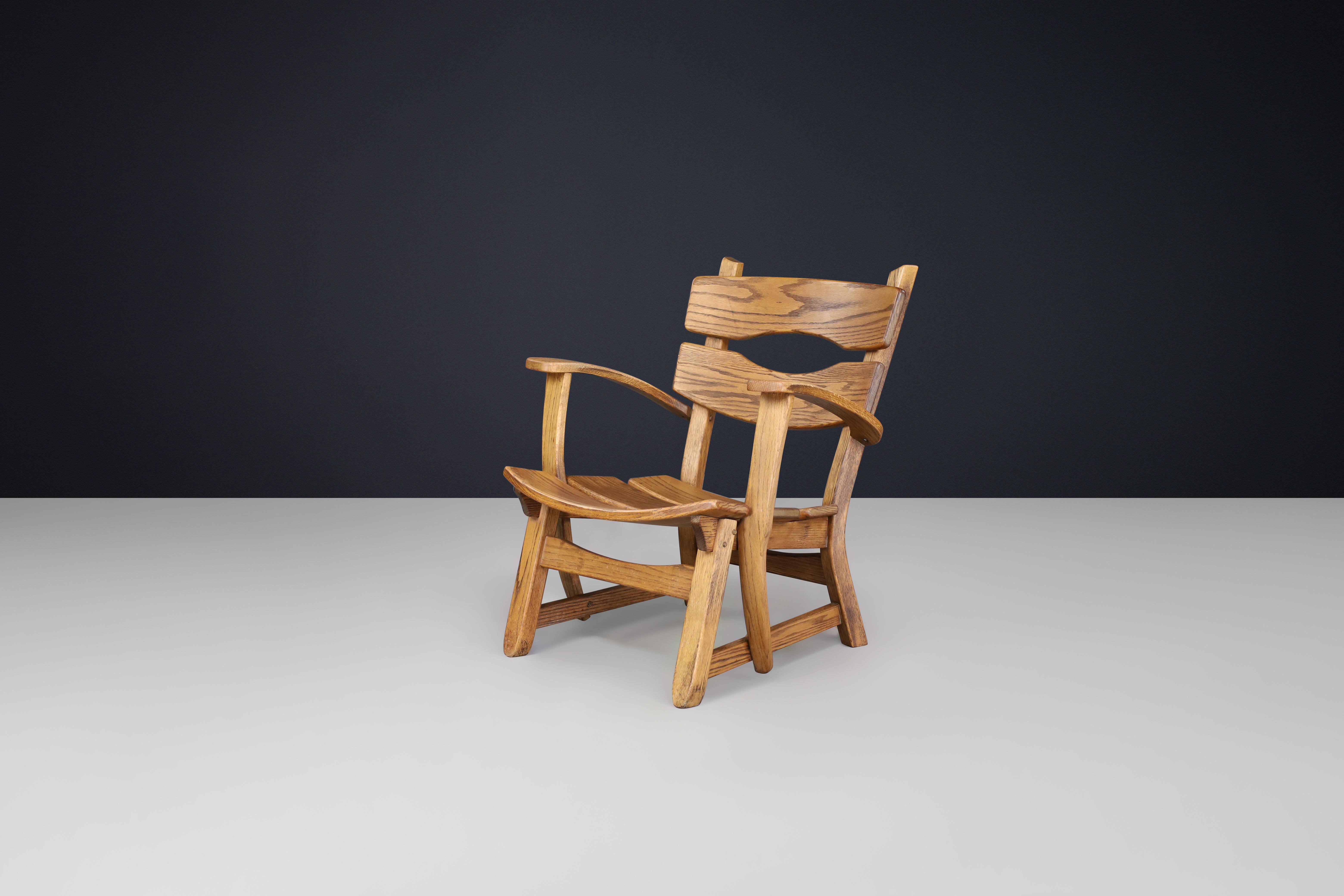Sculptural Mid-Century Armchair in Solid Oak, France, 1950s — 1 Available

A striking piece of French mid-century craftsmanship, this sculptural armchair from the 1950s blends rustic strength with flowing organic form. Crafted entirely from solid