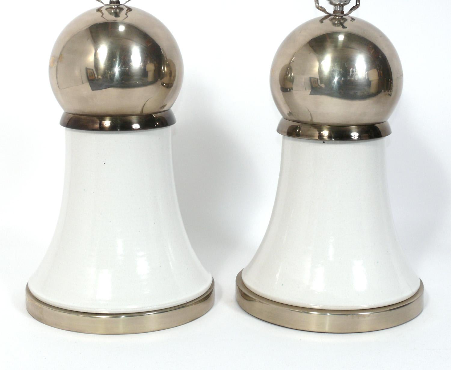 Pair of Sculptural Mid Century Ceramic Lamps in White and Chrome Glaze, attributed to Bitossi, unsigned, Italy, circa 1970s. They have been rewired and are ready to use. They are constructed of white and chrome glazed ceramic vessels on chromed
