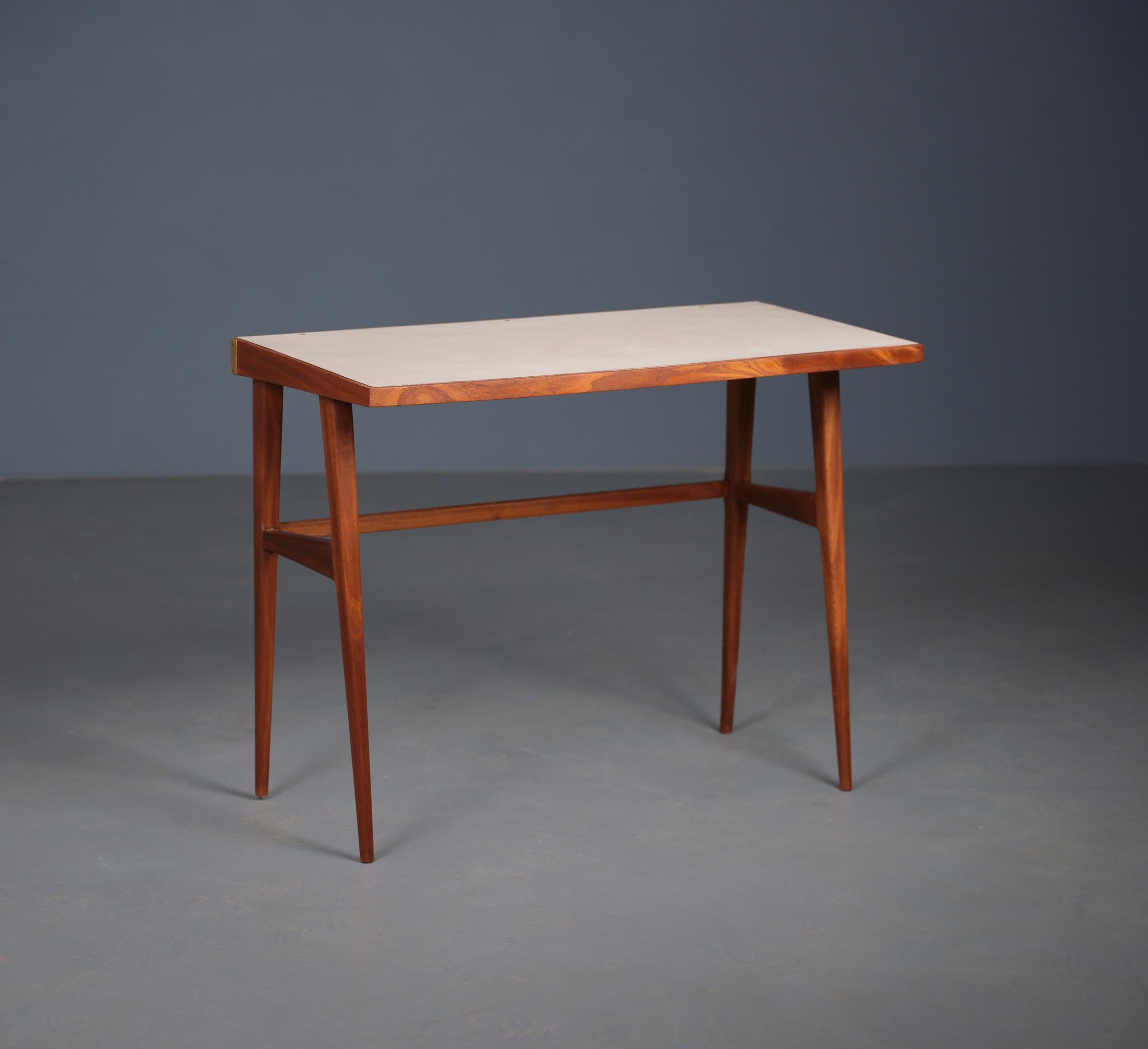 Discover the epitome of Italian craftsmanship with this stunning desk, meticulously designed and produced in the 1950s by F.lli Strada. This piece is a standout example of mid-century modern design, characterized by its sculptural lines and refined