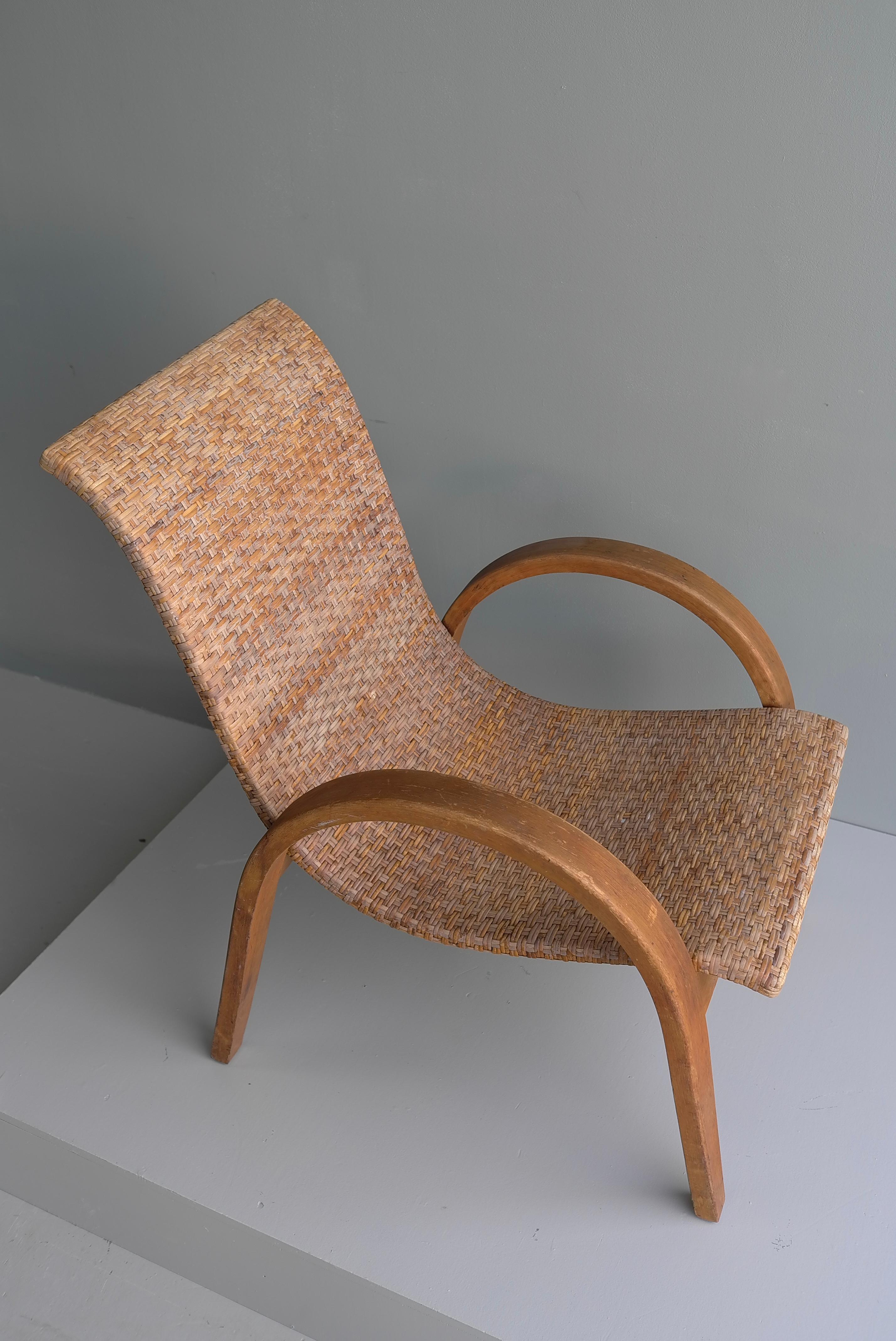 Sculptural Mid-Century Modern armchair in wood and cane, 1950's.