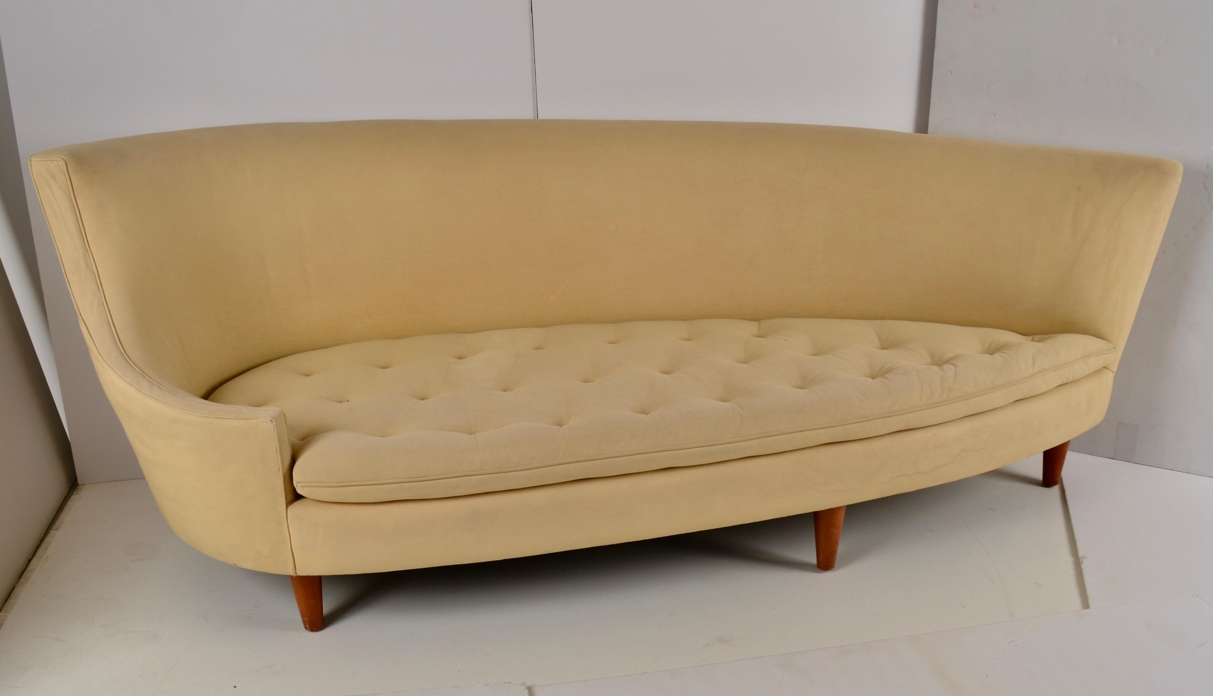 This is one of the most exciting sofa designs we've ever had. Almost space age. Featuring a distinctive shape and whimsically curved back, it also has five legs. Crafted with fine attention to detail and utilizing high quality construction, the sofa