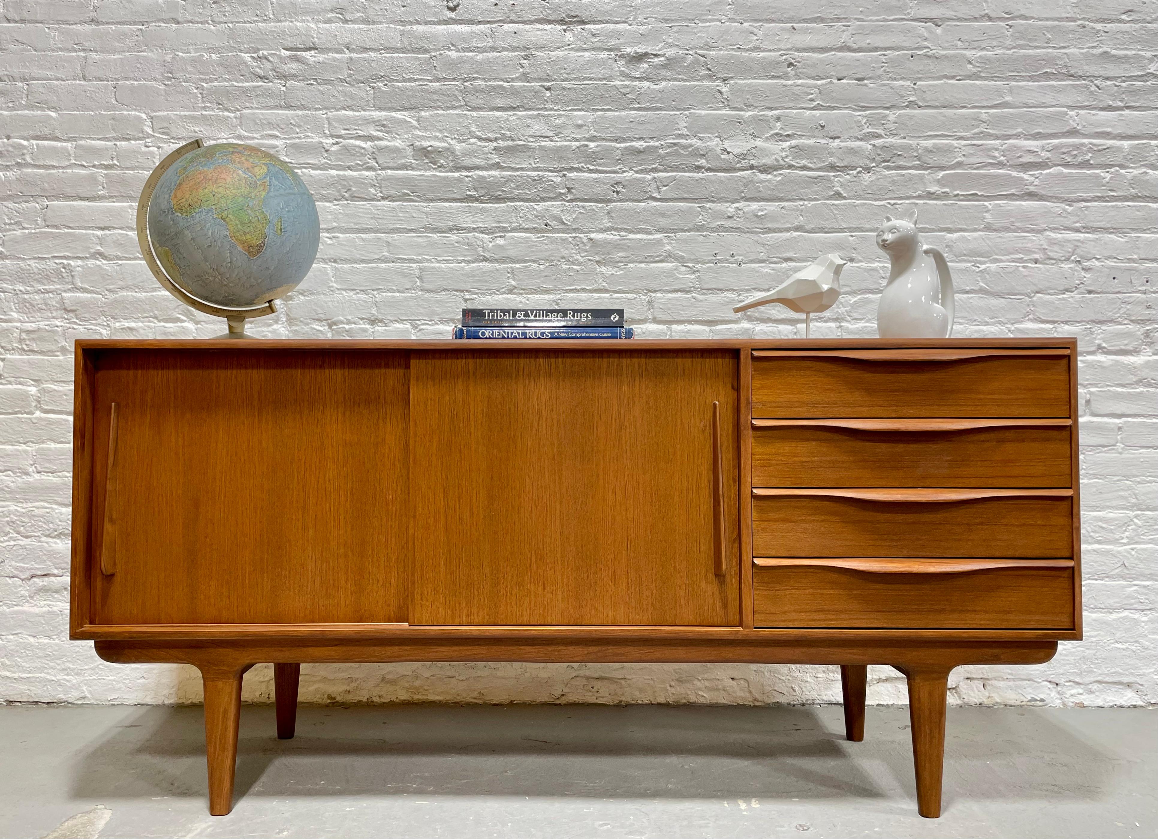 Mid-Century Modern styled Handmade Credenza / Media stand featuring exquisite sculptural hand pulls and plenty of shelving space for all your media components. Stunning wood grains and finished back allow you to float the credenza in a room.