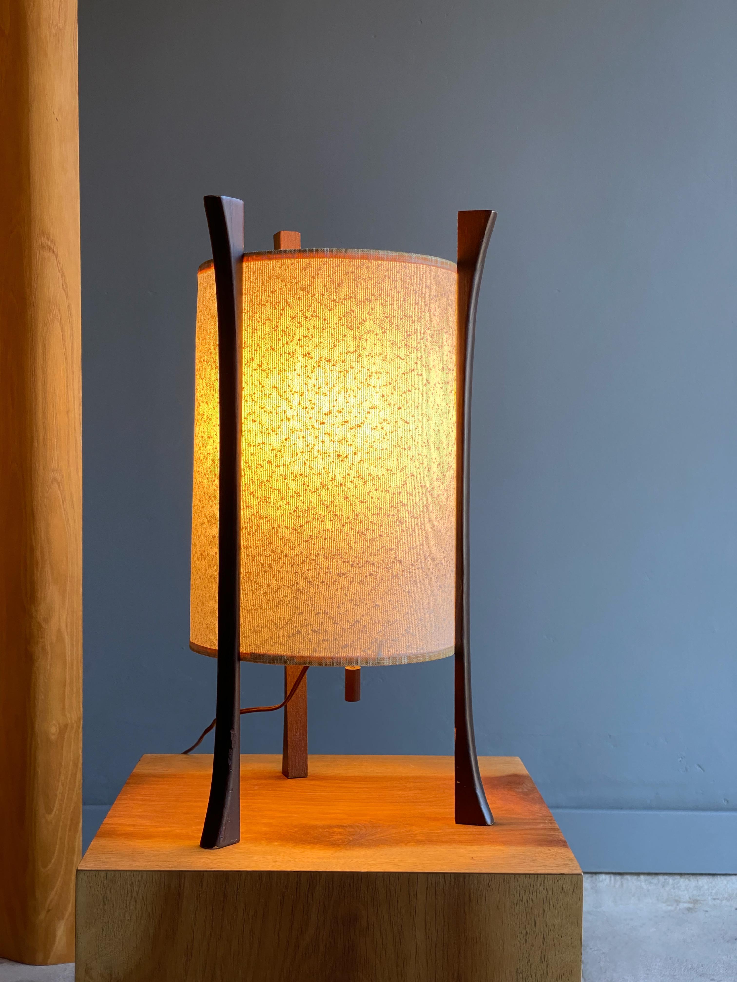 Lovely and unique mid century table lamp. Sculptural form mixed with soft ambient light makes this a perfect mesh with a mid century or Asian influenced interior. Attractive hanging wood pull tab for easy on/off switch.