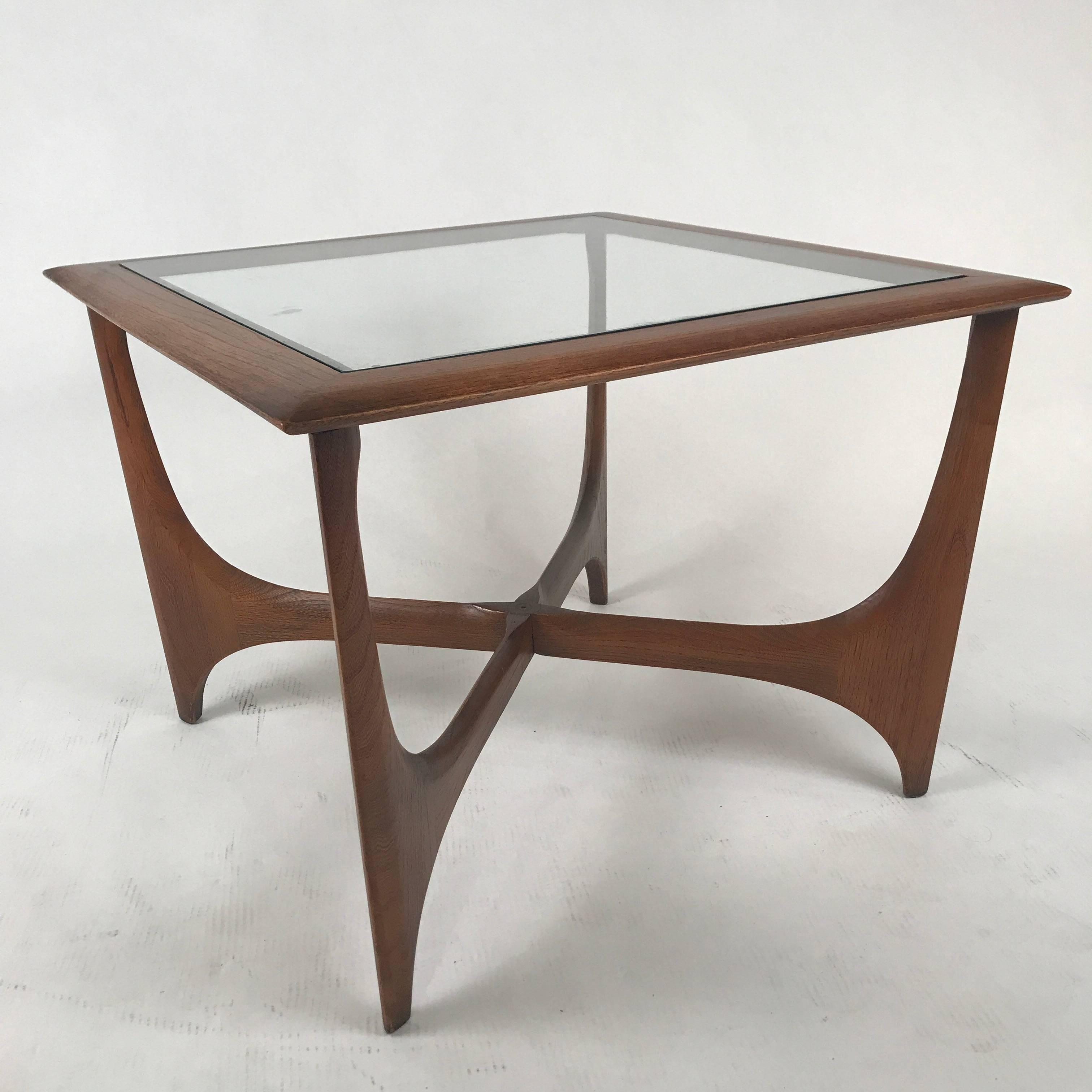 Sculptural end table from 1967 constructed of walnut and glass. Gorgeous classic midcentury design.