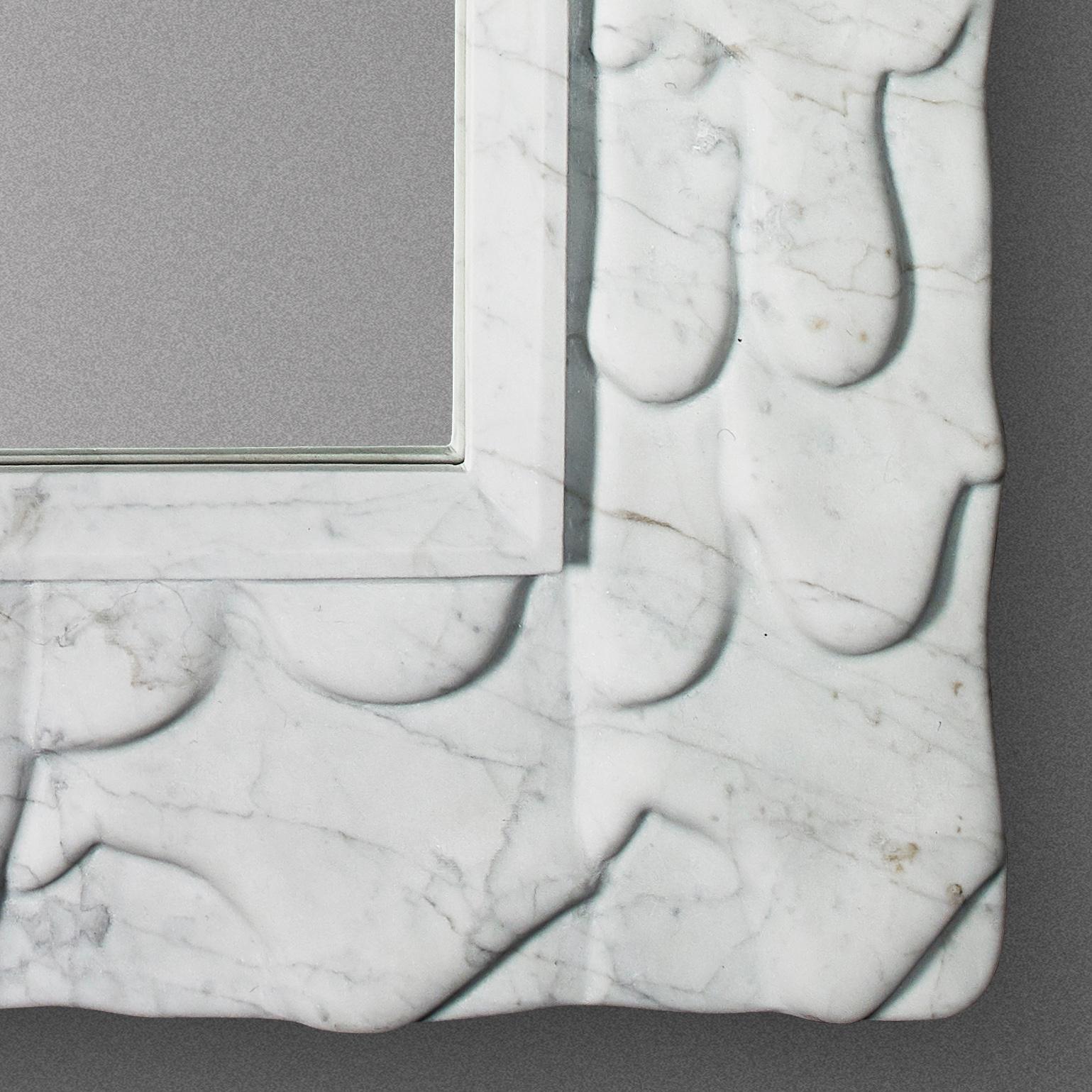 Unique- piece sculptural mirror engraved from a 3cm slab of Carrara marble.
The evolution from sharp hedgy shapes (top side) to smooth round melting material (bottom side).
