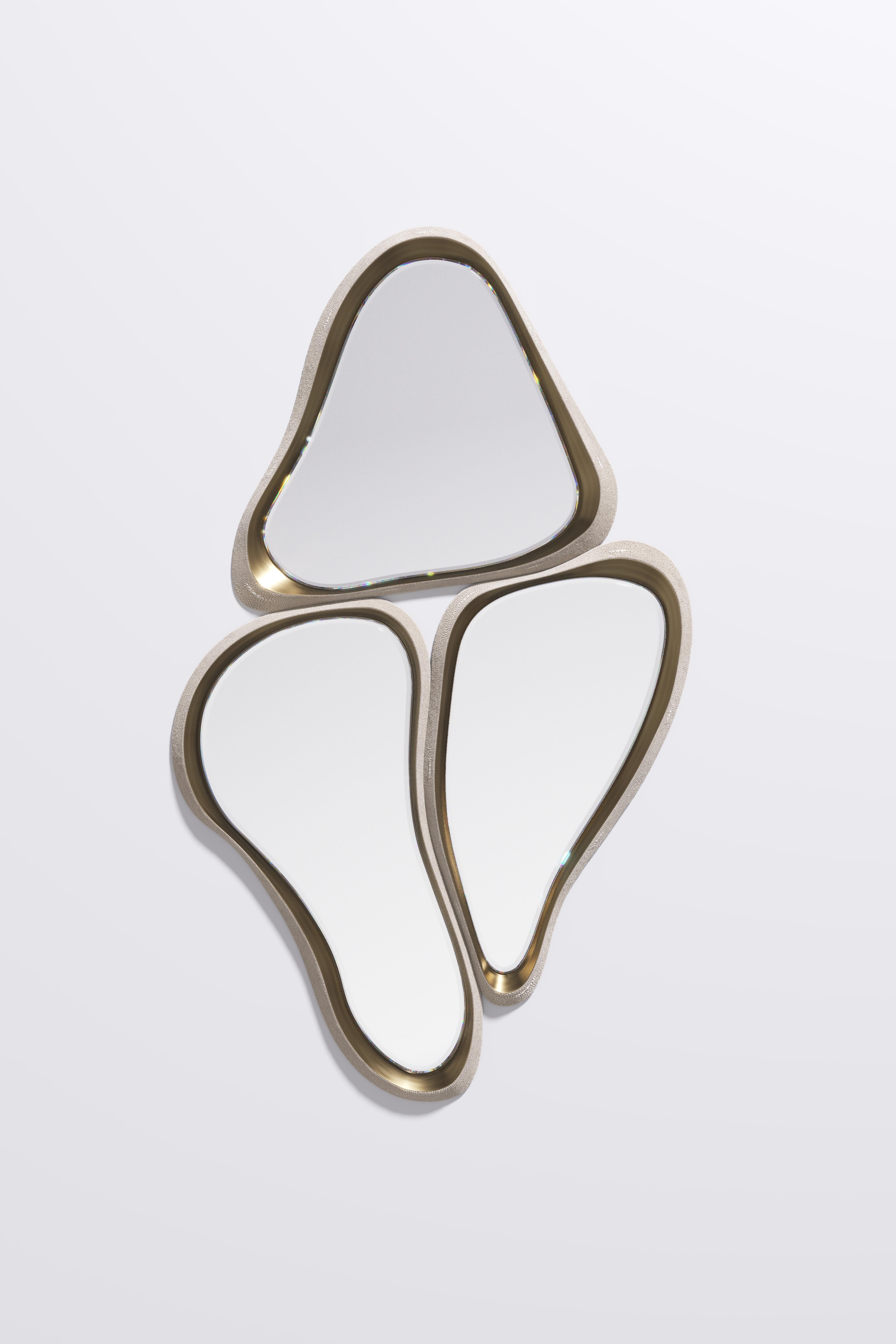 The Mask mirror is a statement and versatile piece. The 3 piece amorphous mirror melt into one another to create a fluid and dramatic expression. The frame is inlaid in bronze-patina brass. Available in other finishes This piece is designed by Kifu