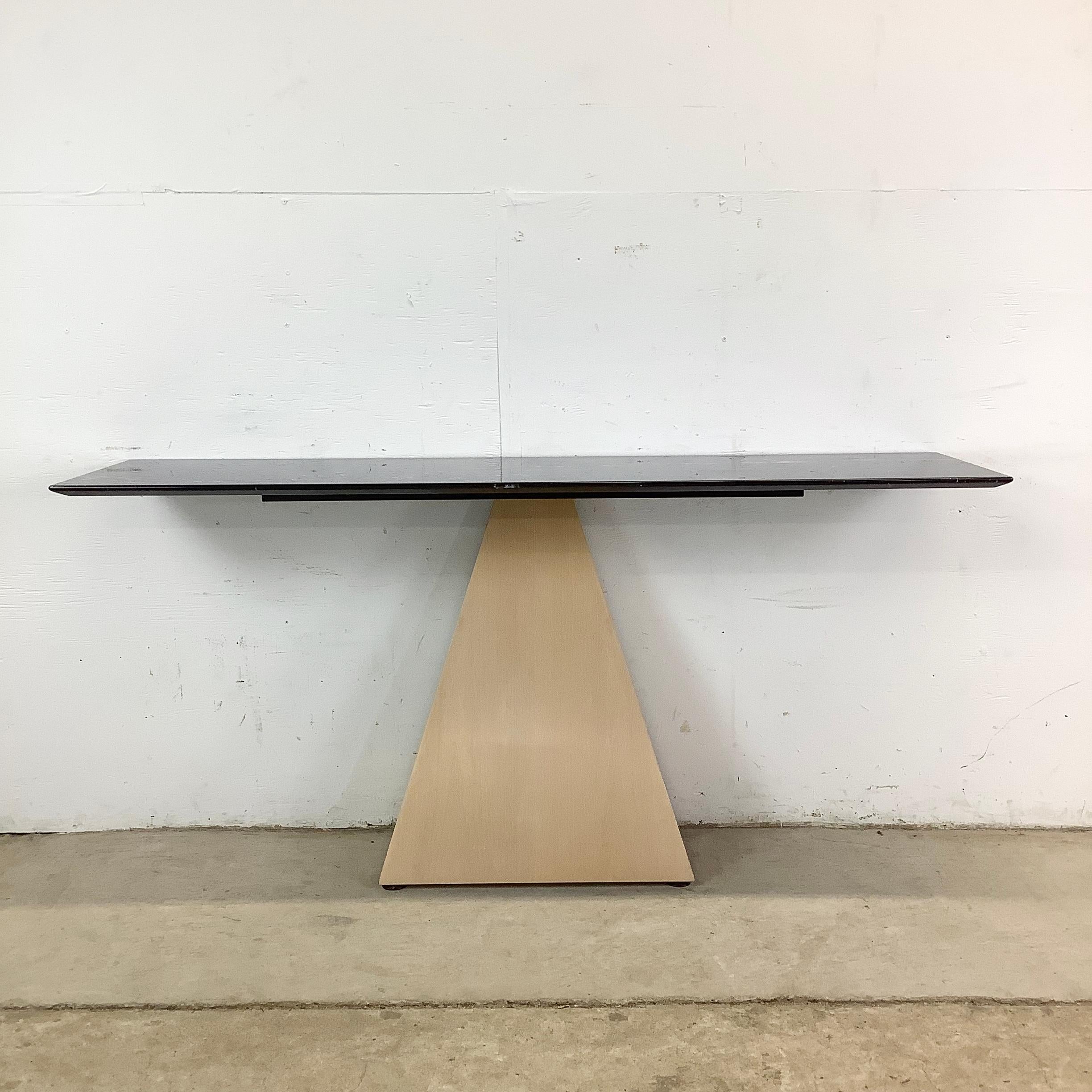 The fusion of form and function is masterfully realized in this bold console table, where sculptural geometry meets refined materials. With a black stone slab top and a pyramid-style base, this piece is designed to command attention in any