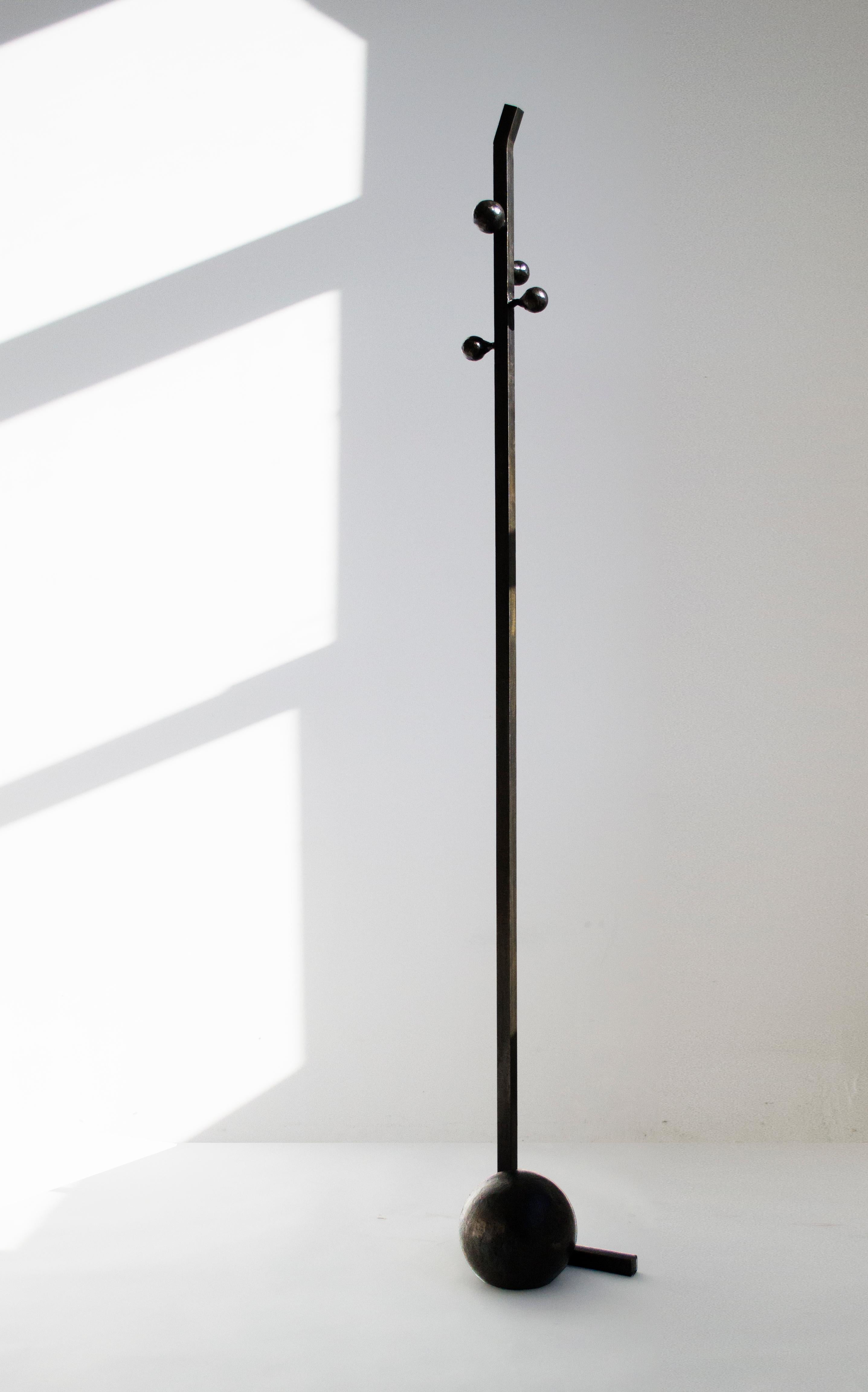 COAT RACK
J.M. Szymanski
d. 2017

This unique coat stand is contemporary sculpture. A solid cast sphere supports a slender stand, which can hold between 5-8 coats on it. 

Made in the Bronx, New York, USA.

Our products are fabricated and finished