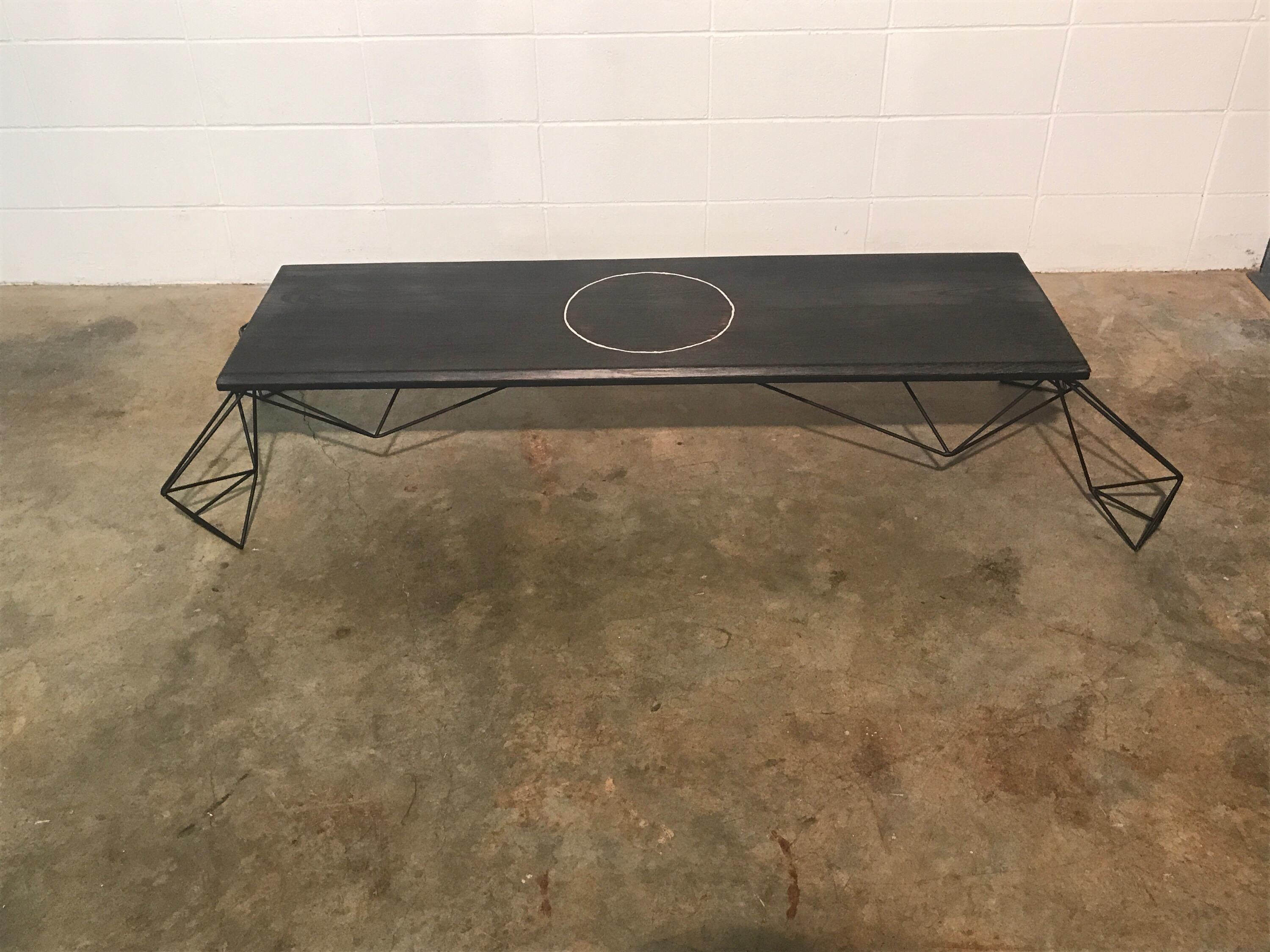 Sculptural modern geometric custom designed and fabricated coffee table. This stunning table has the perfect blend of sleek modernism and beautifully grained ebonized hardwood plus a metal inlay. It was designed and fabricated by Joshua Shorey.