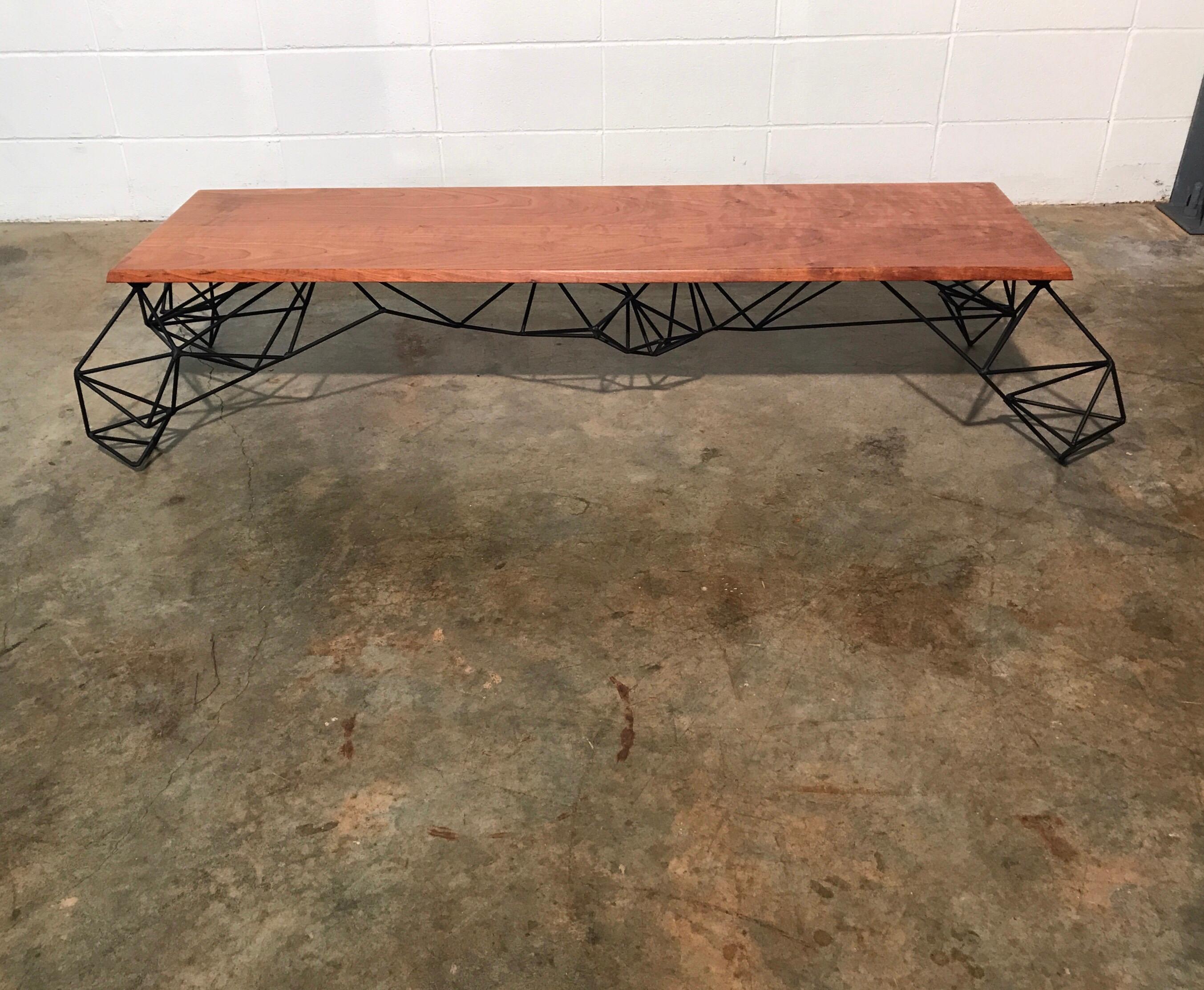 Sculptural modern geometric custom designed and fabricated coffee table. This stunning table has the perfect blend of sleek modernism and beautifully grained hardwood. It was designed and fabricated by Joshua Shorey. Joshua has a MFA in Sculpture