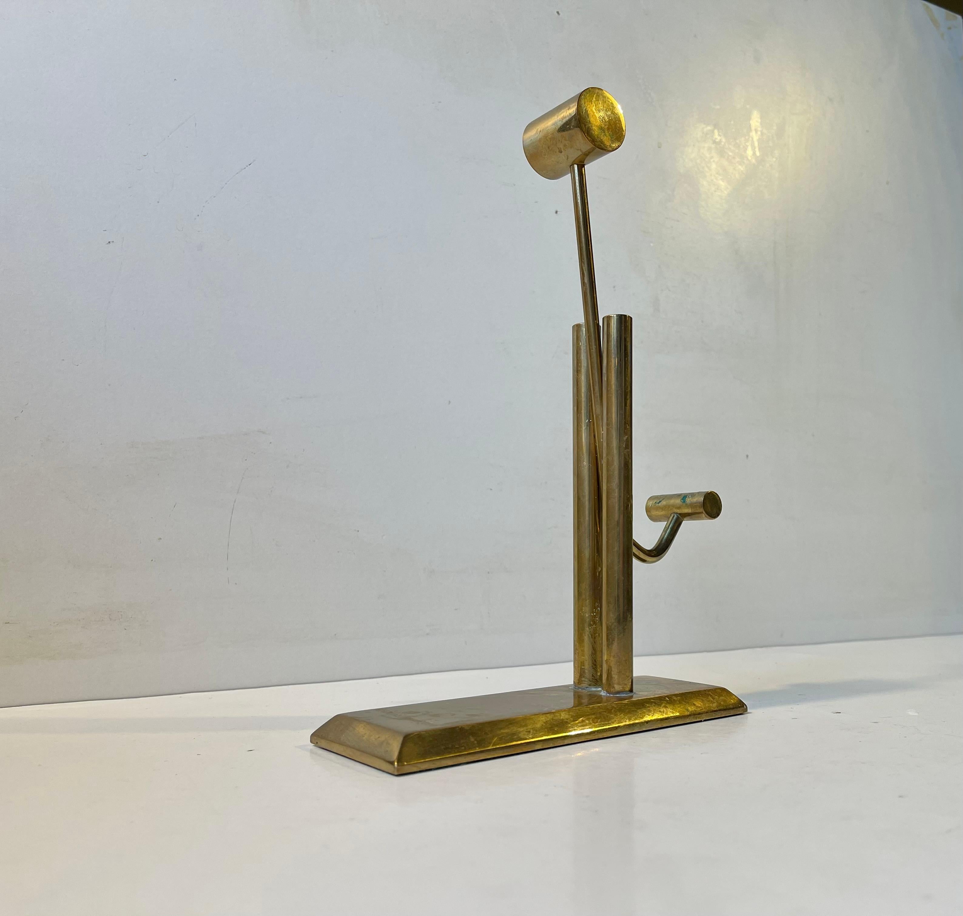 A very well-, heavy and steady made counterweighted paper holder in solid bronze. It resembles an oil pump. Presumably custommade and handed as a gift to an employe of the Danish Correctional Service as a celebration of 25 years in service