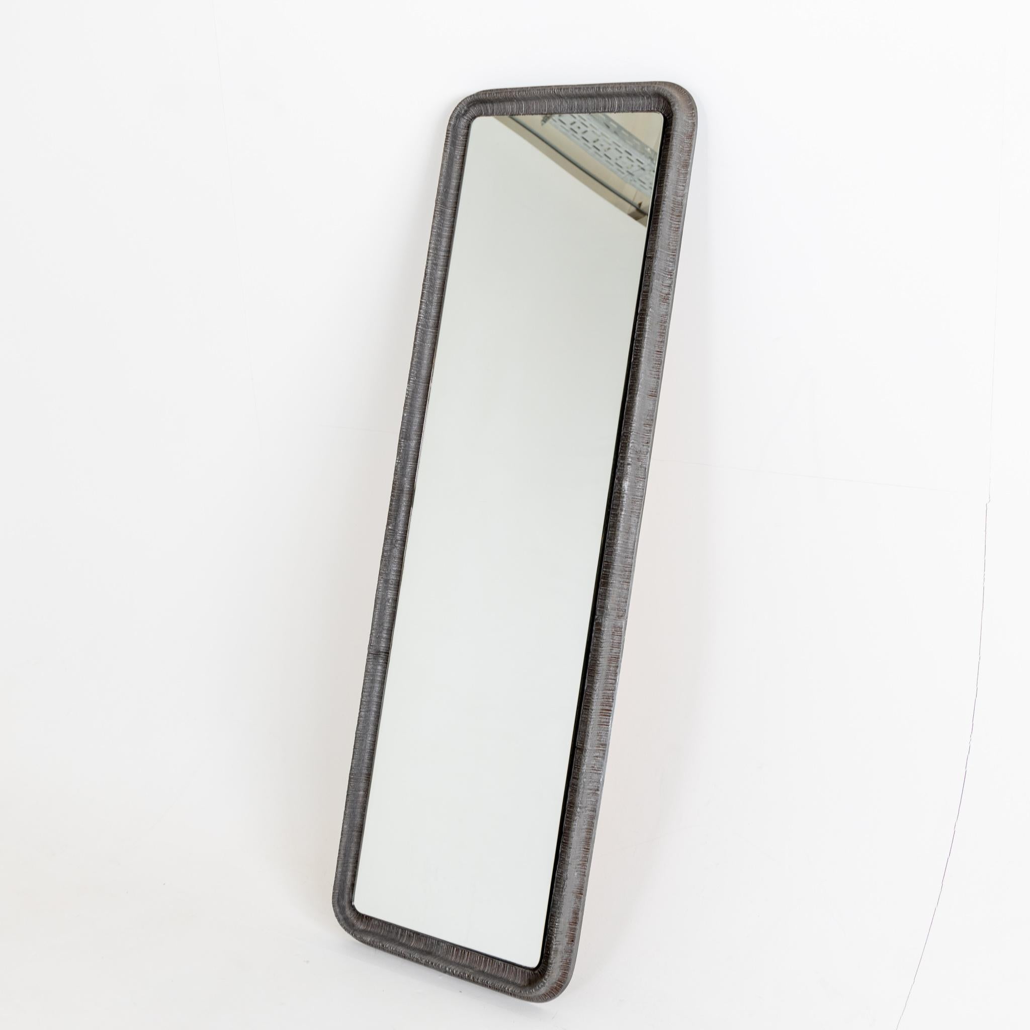Tall sculptural Modernist mirror by artist Lorenzo Burchiellaro. 
Textured cast aluminum. Signed Burchiellaro.
