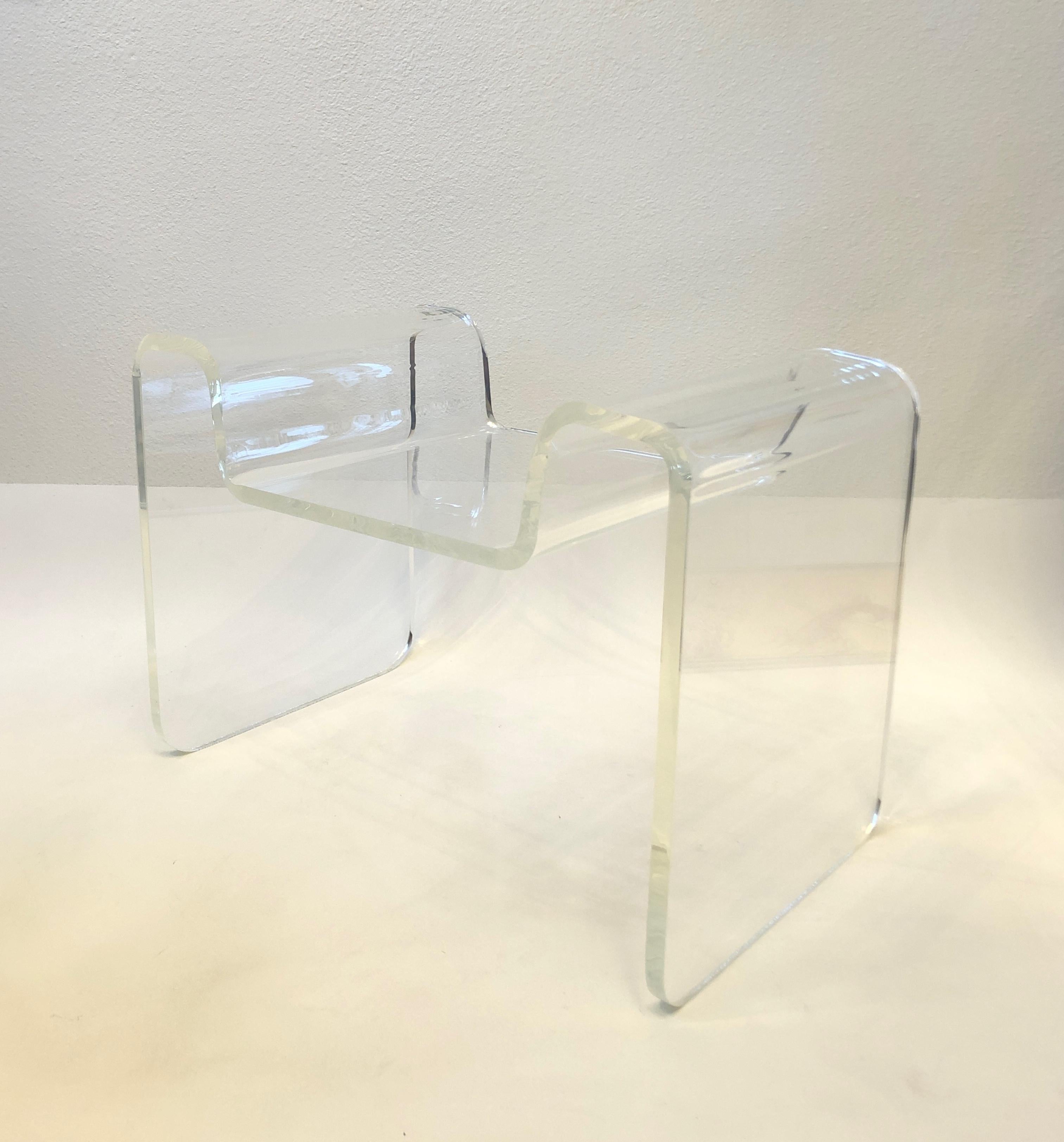 1970’s Sculptural clear acrylic bench by Karl Springer.
Constructed of one piece of acrylic that’s molded in to shape. 
Newly professionally polished.
Measurements: 28” Wide, 16” Deep, 19” High, 14.25” Seat.