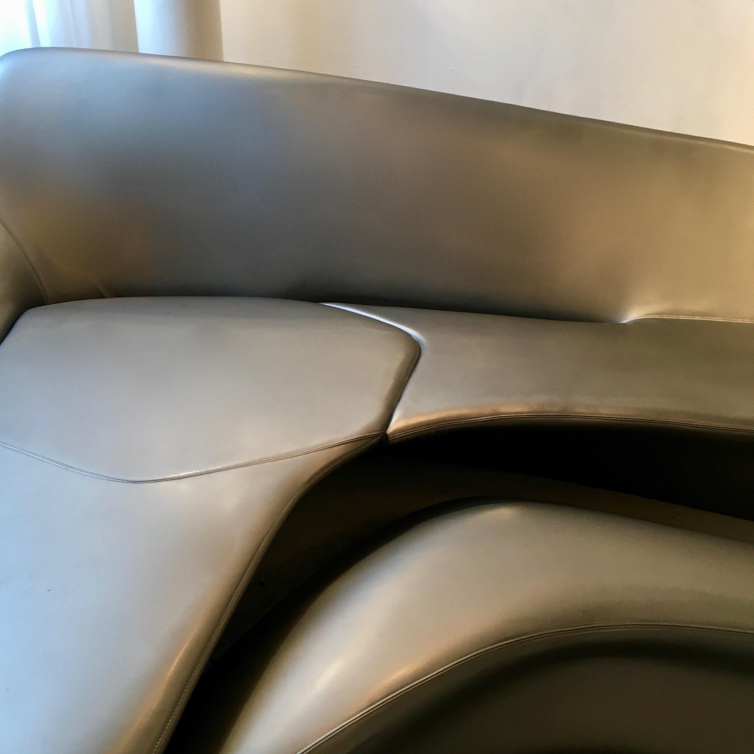 Specular futuristic Moon System sofa, three separates pieces including the ottoman.
Steel structure filled with foam. Silver vinyl cover.
Designed by Zaha Hadid for B&B Italy around 2008.