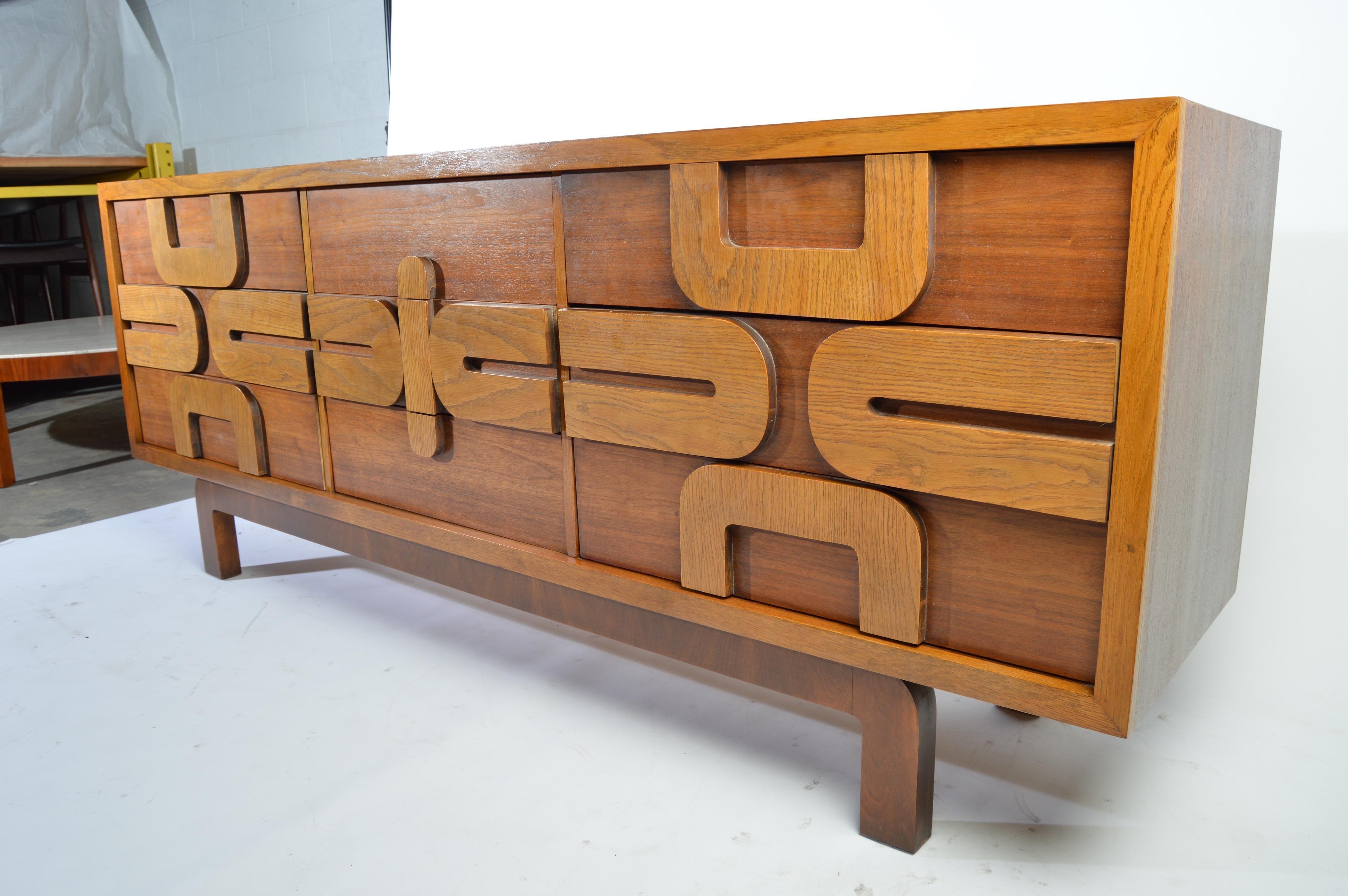 A midcentury 9 drawer dresser having a sculptural mosaic oak front with beautifully contrasted walnut case by Lane Altavista,
circa 1960. Signature inside top left drawer.
 