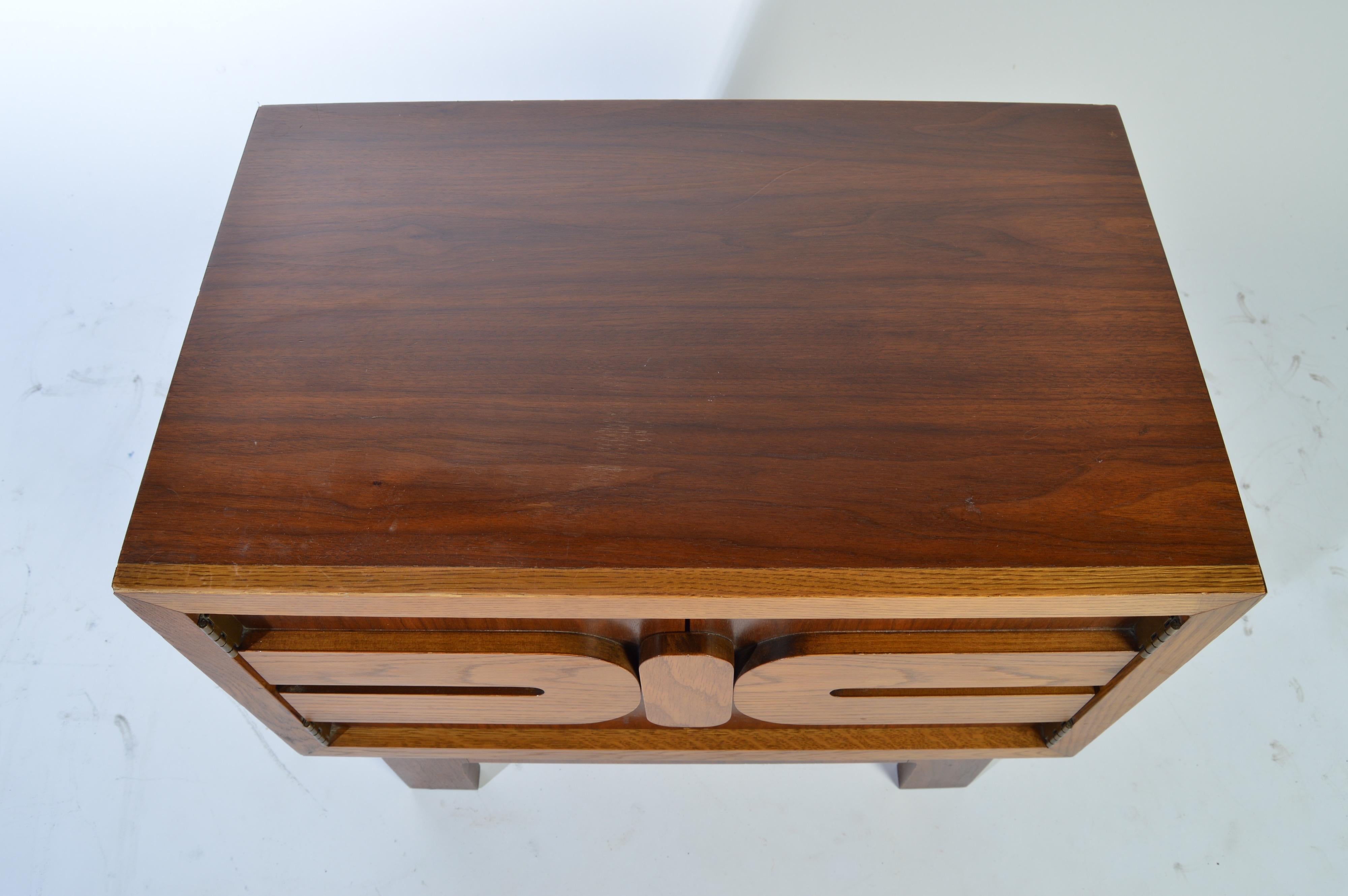 A midcentury nightstand having a sculptural mosaic oak front with beautifully contrasted walnut case by Lane Altavista, circa 1960.
   