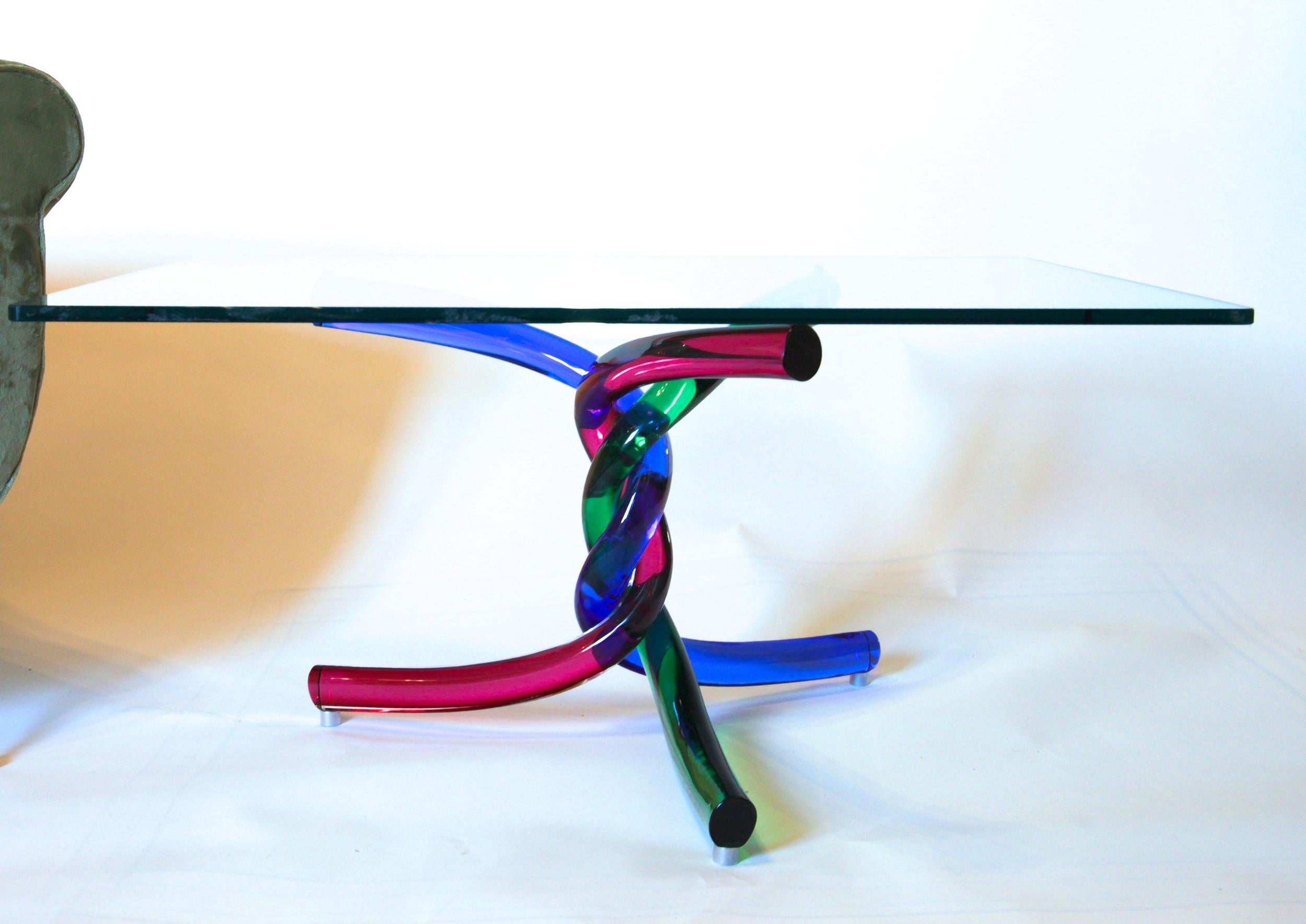 Sculptural glass table made with 3 twisted Murano made rods.

This is the first series of the Torsade cocktail table, designed by Maurice Barilone and edited by Reflex.
It's one of the best cocktail tables design that I have seen. An incredible