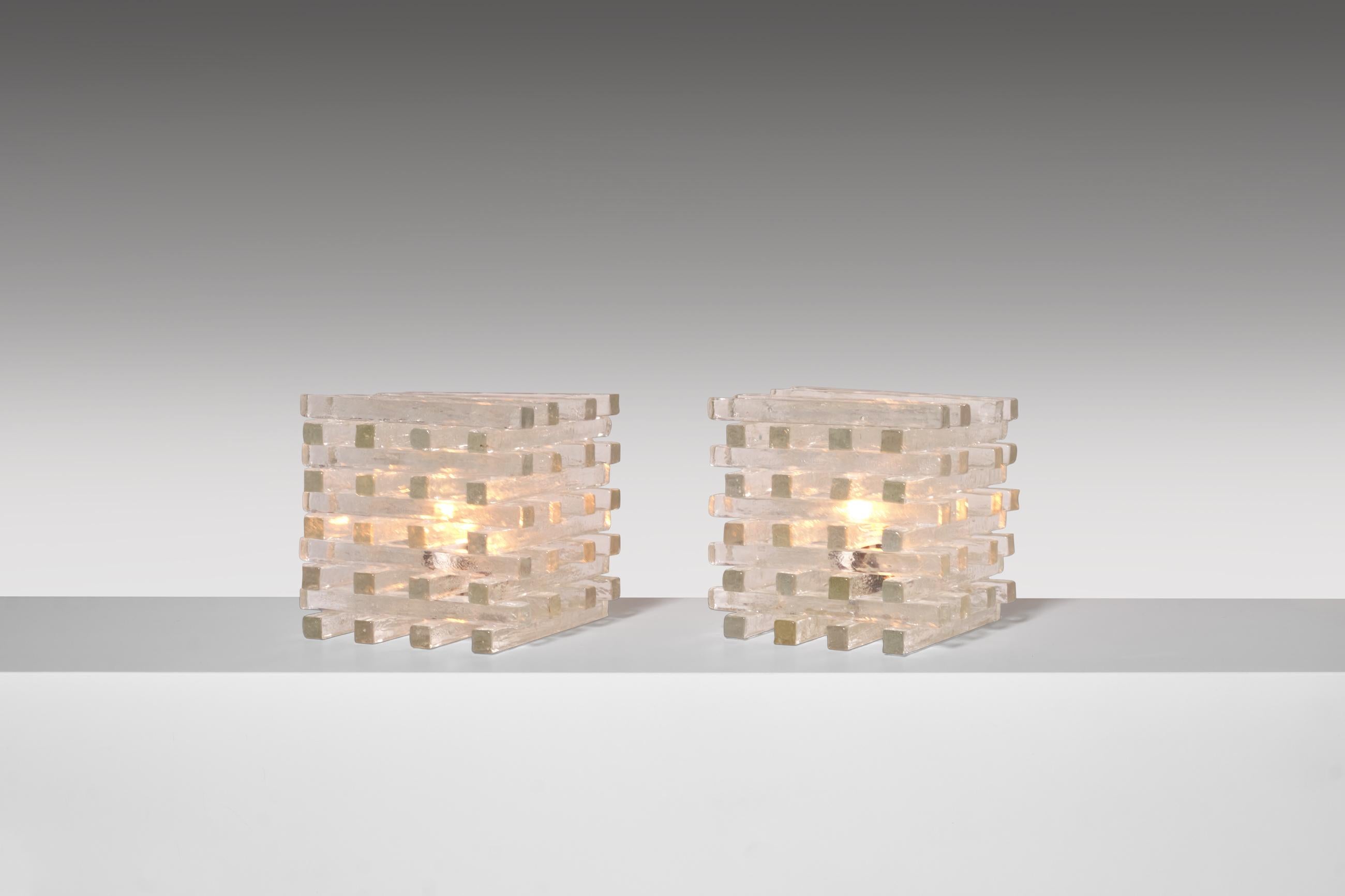 Exceptional set of two cubistic table lamps by Poliarte, Italy, 1960s. Made out of stacked Murano glass slats, which are all handcrafted with each their own unique structure. The glass structure provides an interesting and warm light partition. In