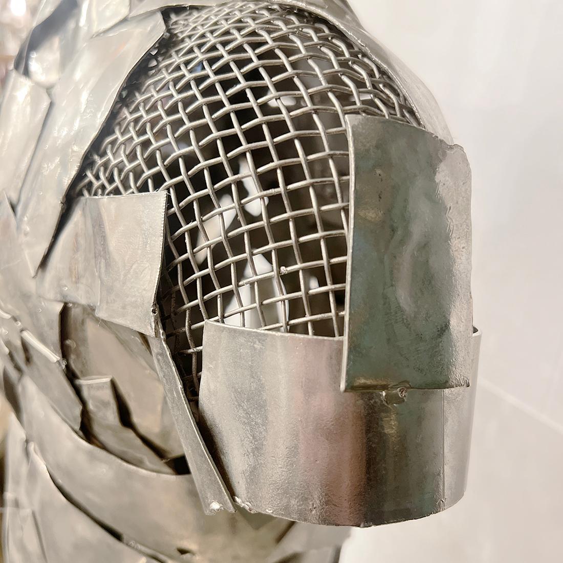 A circa 1950's Italian nickel plated sculptural lamp depicting a man with 1 interior Edison light.

Measurements:
Height: 50