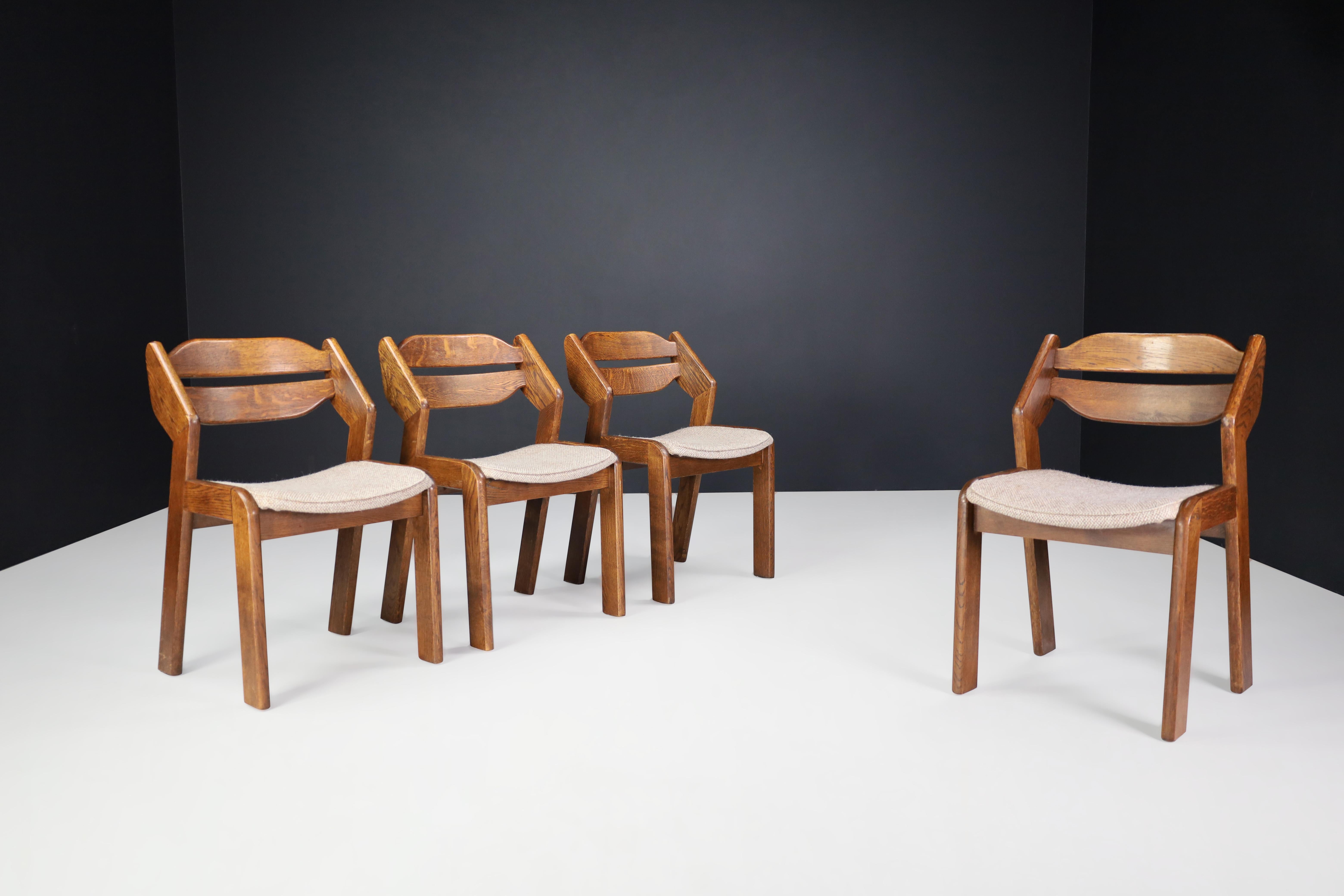 Sculptural oak and fabric dining chairs, France, 1960s

Set of four sculptural oak and fabric dining chairs, France, 1960s. These chairs are made entirely of wood and rush. They are in excellent original condition. The color of the wood is very