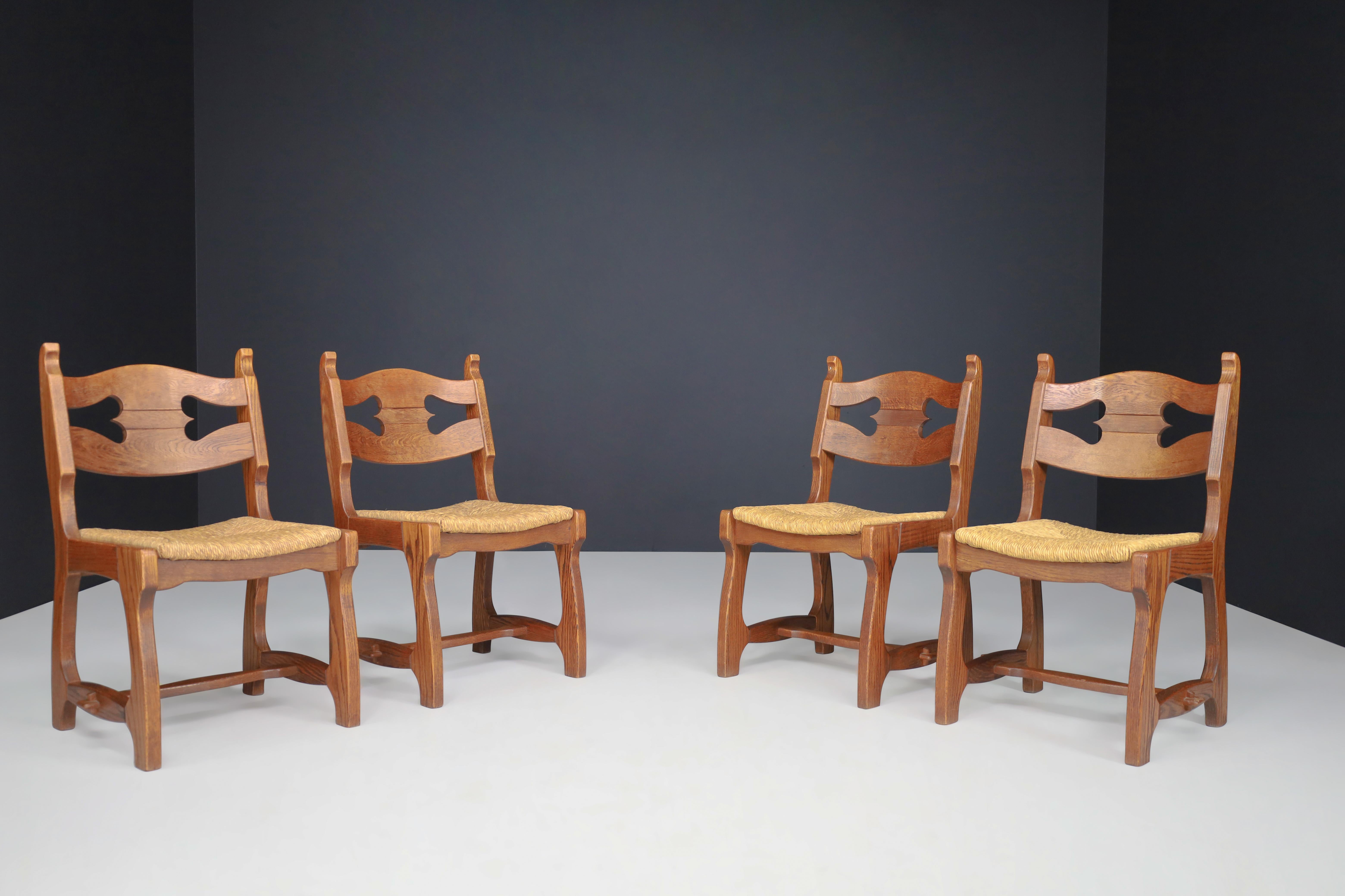 Sculptural oak and rush dining chairs, France, 1960s

Set of four sculptural oak and rush dining chairs, France, 1960s. These chairs are made entirely of wood and rush. They are in excellent original condition. The color of the wood is very warm