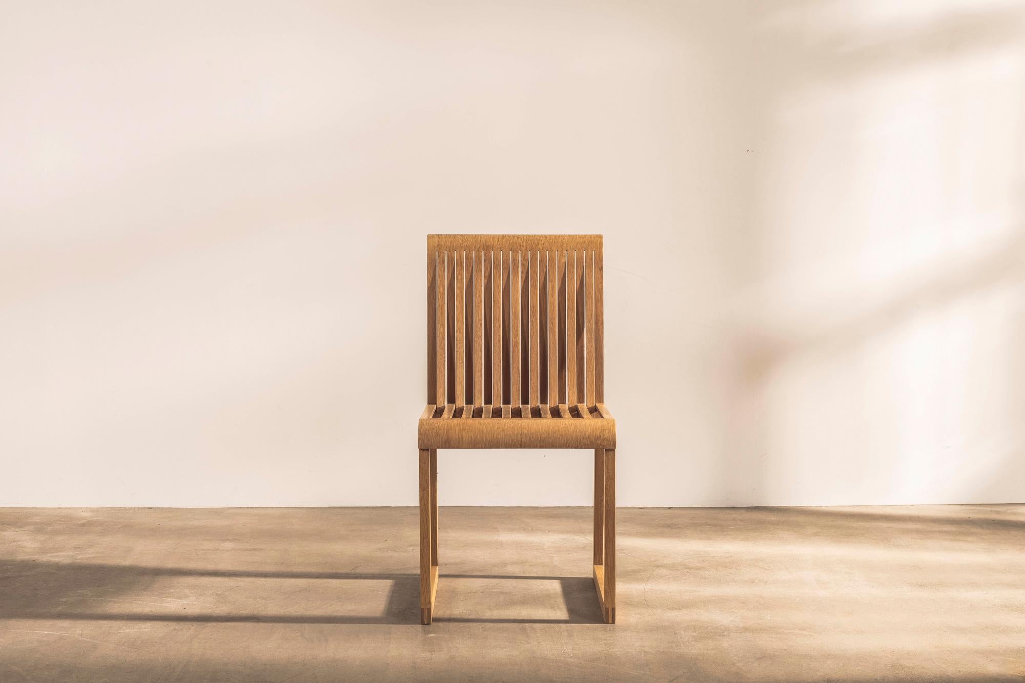 This sculptural oak chair with a clear lacquer finish is a fine example of the creativity and playfulness of industrial and furniture designers Shin and Tomoko Azumi. 

An original model sourced from the manufacturer, it has a seat and back