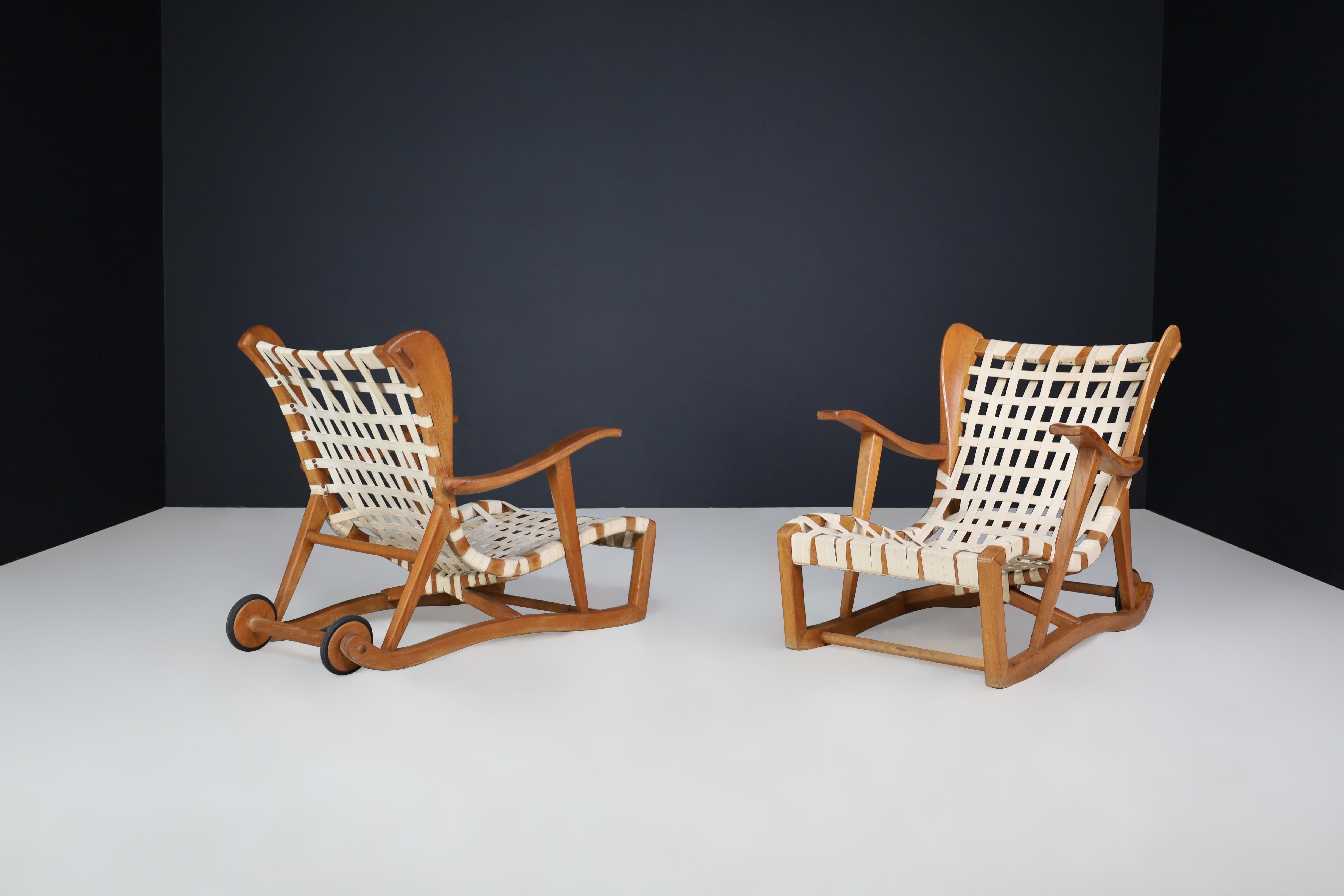 Sculptural oak Lounge chairs by Guglielmo Pecorini, Italy, the 1950s

These lounge chairs are a midcentury design by Guglielmo Pecorini from the 1950s. They are made of oak frames and linen straps with two back wheels. Although they show some signs