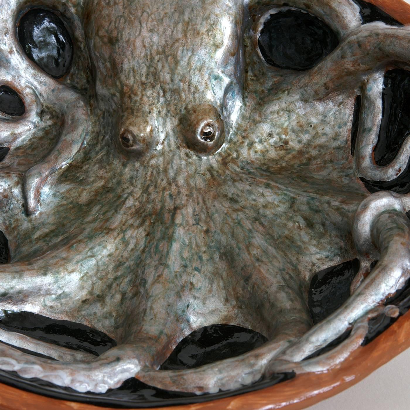 This realistic sculptural bowl in papier-maché depicts an octopus spiralled out in a bath. This striking decoration is painted by hand with natural pigments, and then given a polished resin finish. The piece is reproducible but with minor