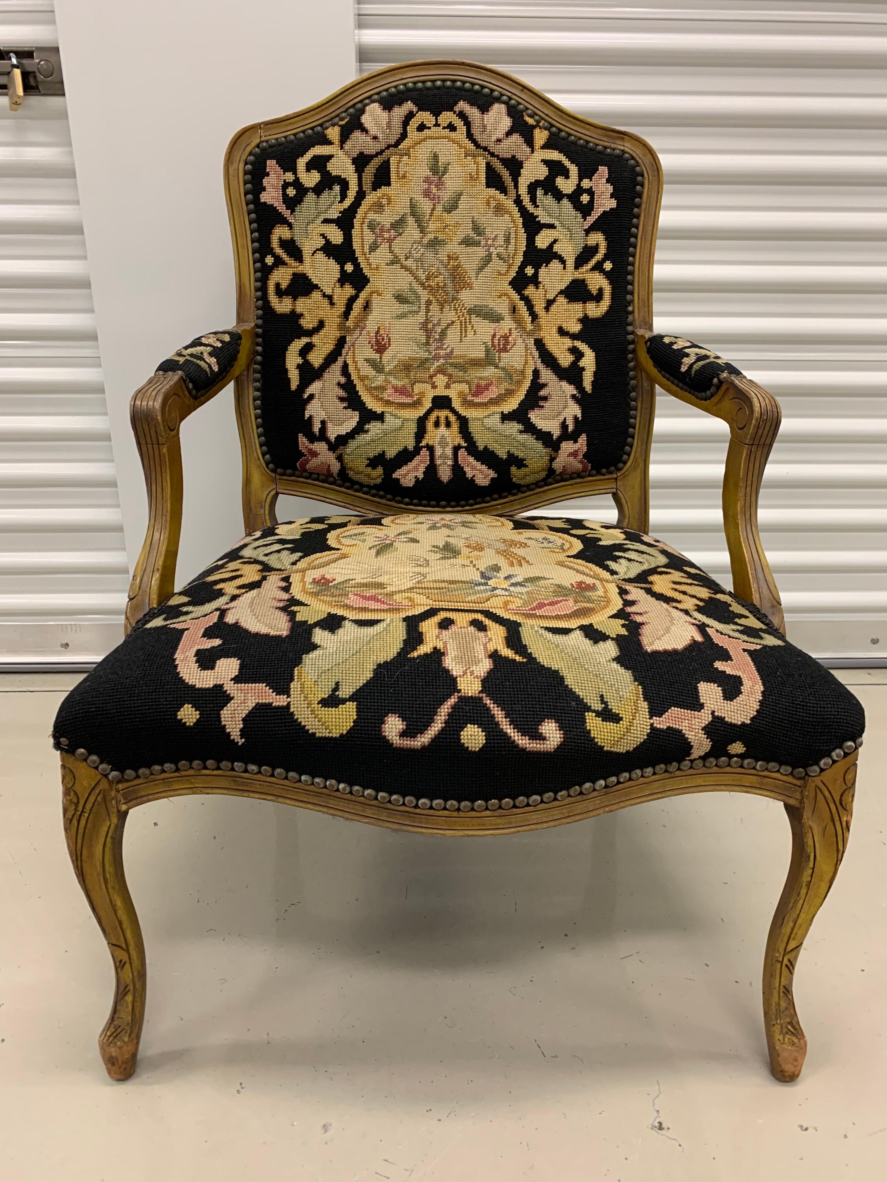 Elegant needlepoint open air armchair. Needlepoint has a wonderful color scheme, see pictures.
There are nailheads throughout.  Note the back of the seat back is unfinished.