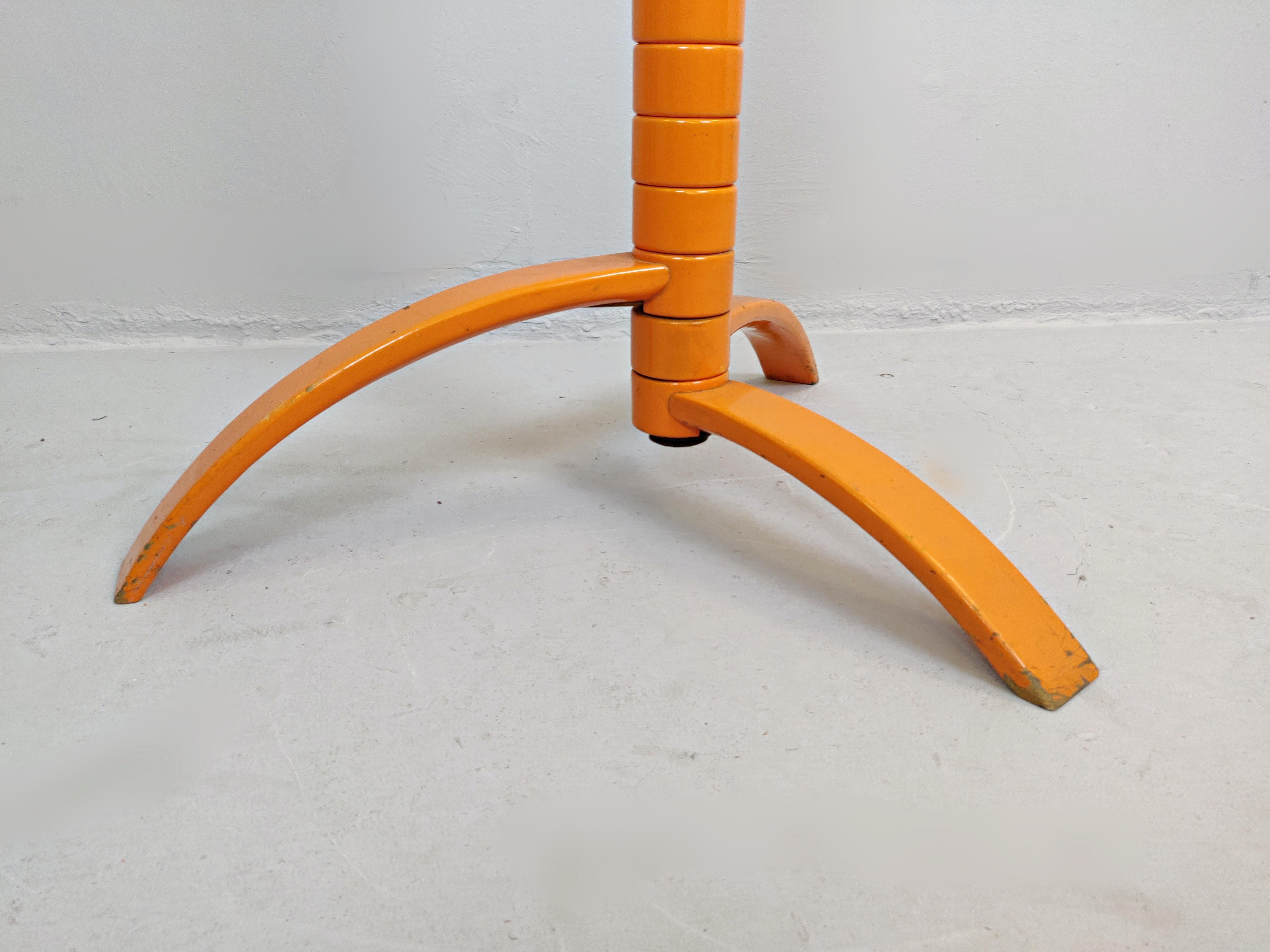 Sculptural orange lacquered wood coat rack by Bruce Tippett Renna.