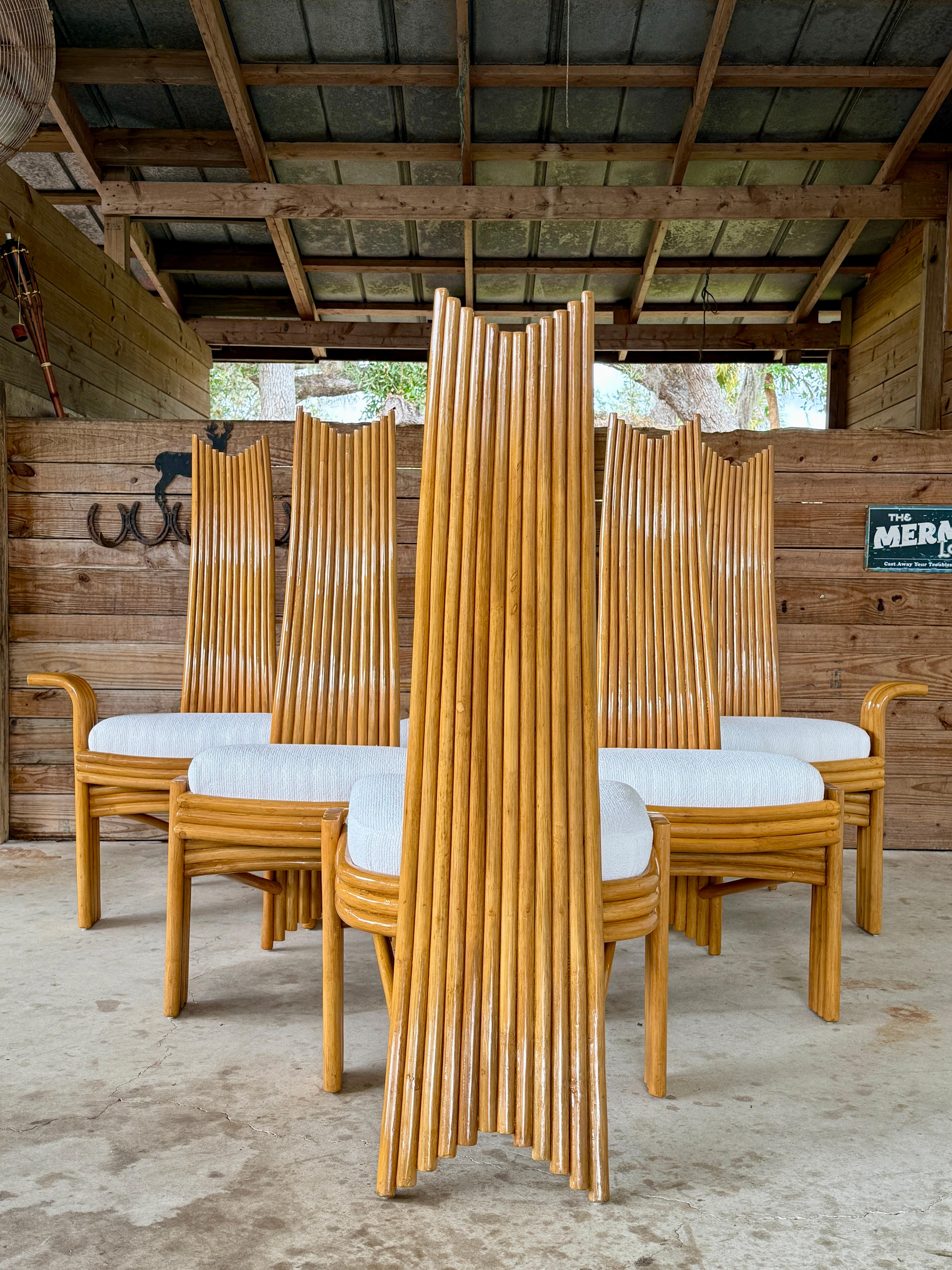 Set of Six High-Back Sculptural Rattan Dining Chairs with 2 Arm and 4 Side Chairs, Mid-20th Century.
This striking set features dramatic curved rattan backs, sculptural silhouettes, and a warm honey-toned finish.
The chairs have been meticulously