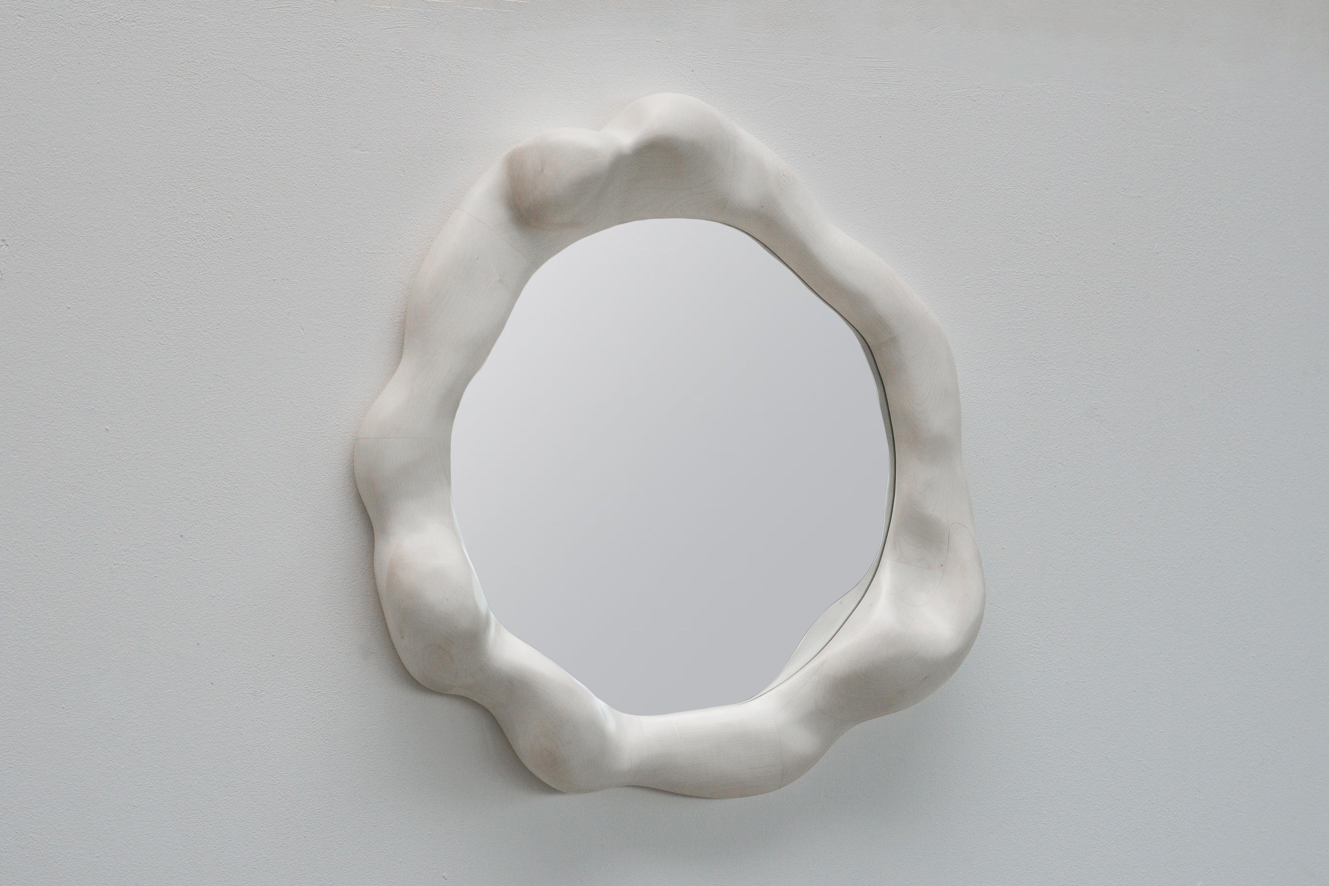 The frame of the crystal mirror is shaped using various hand tools, making each piece unique with its own distinctive wood grain. The mirrorframe is made from high-quality maple, which is bleached and finished with a hardwax oil. 

The mirror is