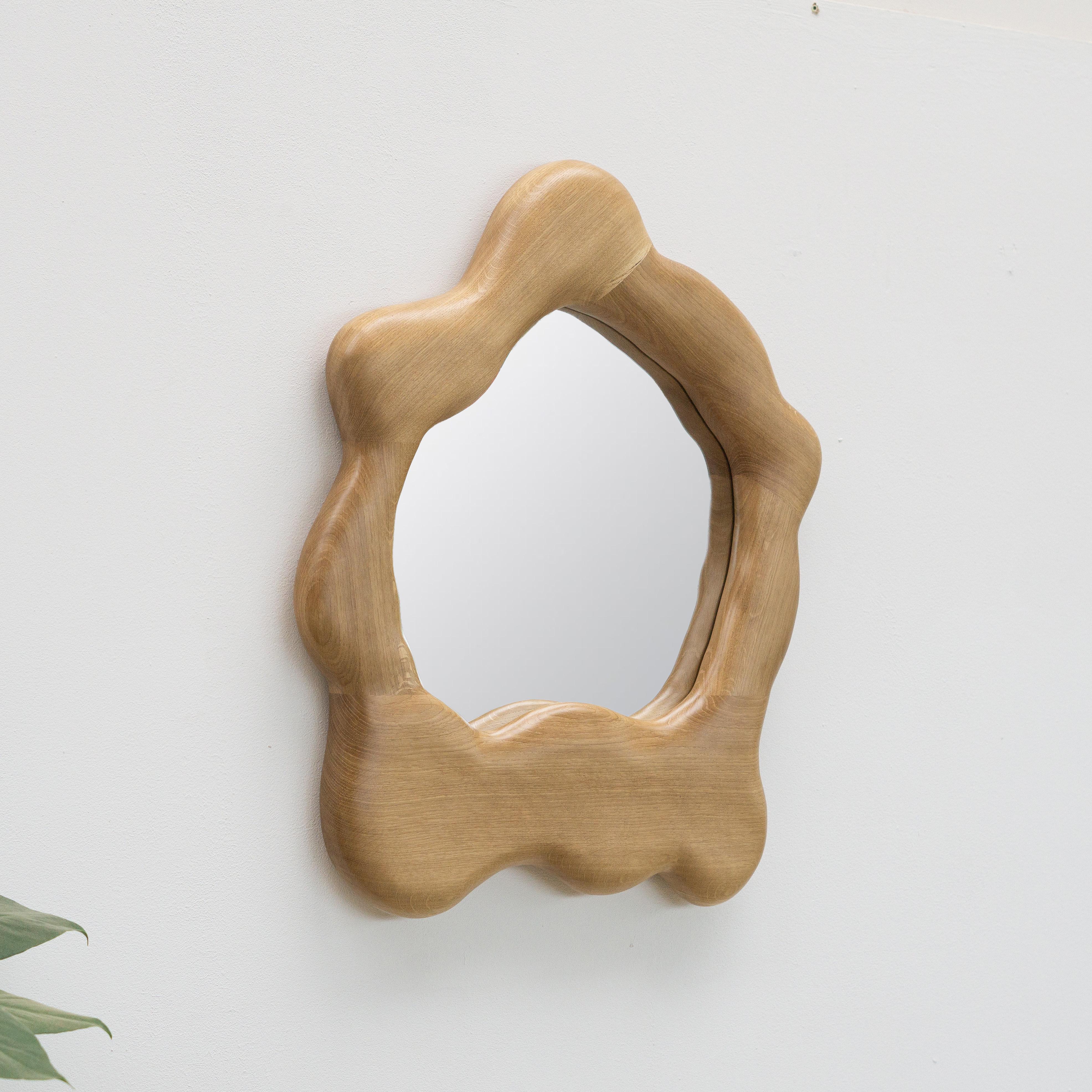 The frame of the mirror is shaped using various hand tools, making each piece unique with its own distinctive wood grain. The mirror is made from high-quality oak and finished with a hardwax oil.

The mirror is mounted on the wall by hanging it on a