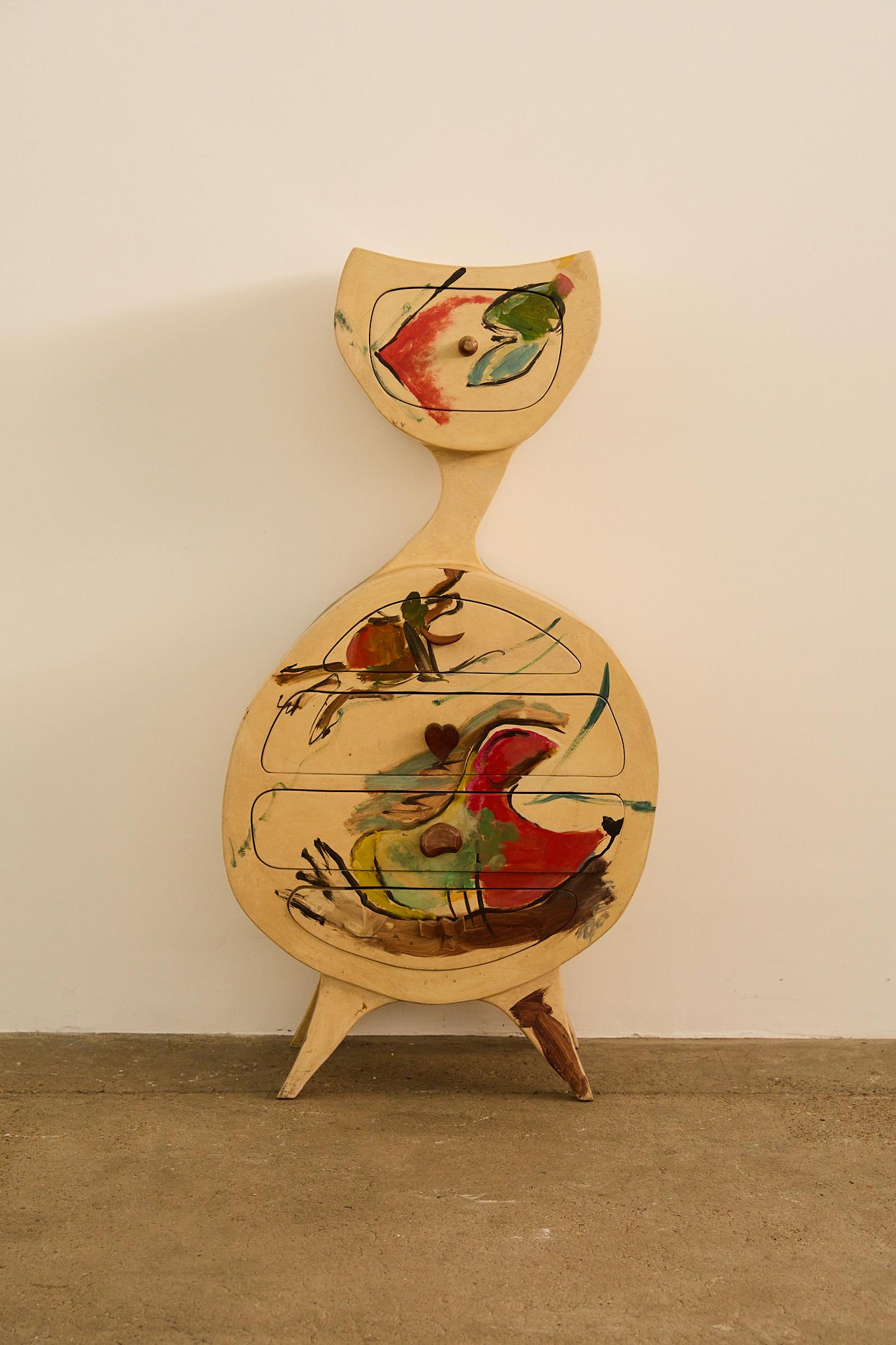 A French sculptural chest of drawers from the 1970s, featuring an organic silhouette and hand-painted abstract motifs in bold colours. Its seamless drawers with whimsical wooden pulls, including a heart-shaped one, make it a striking blend of art