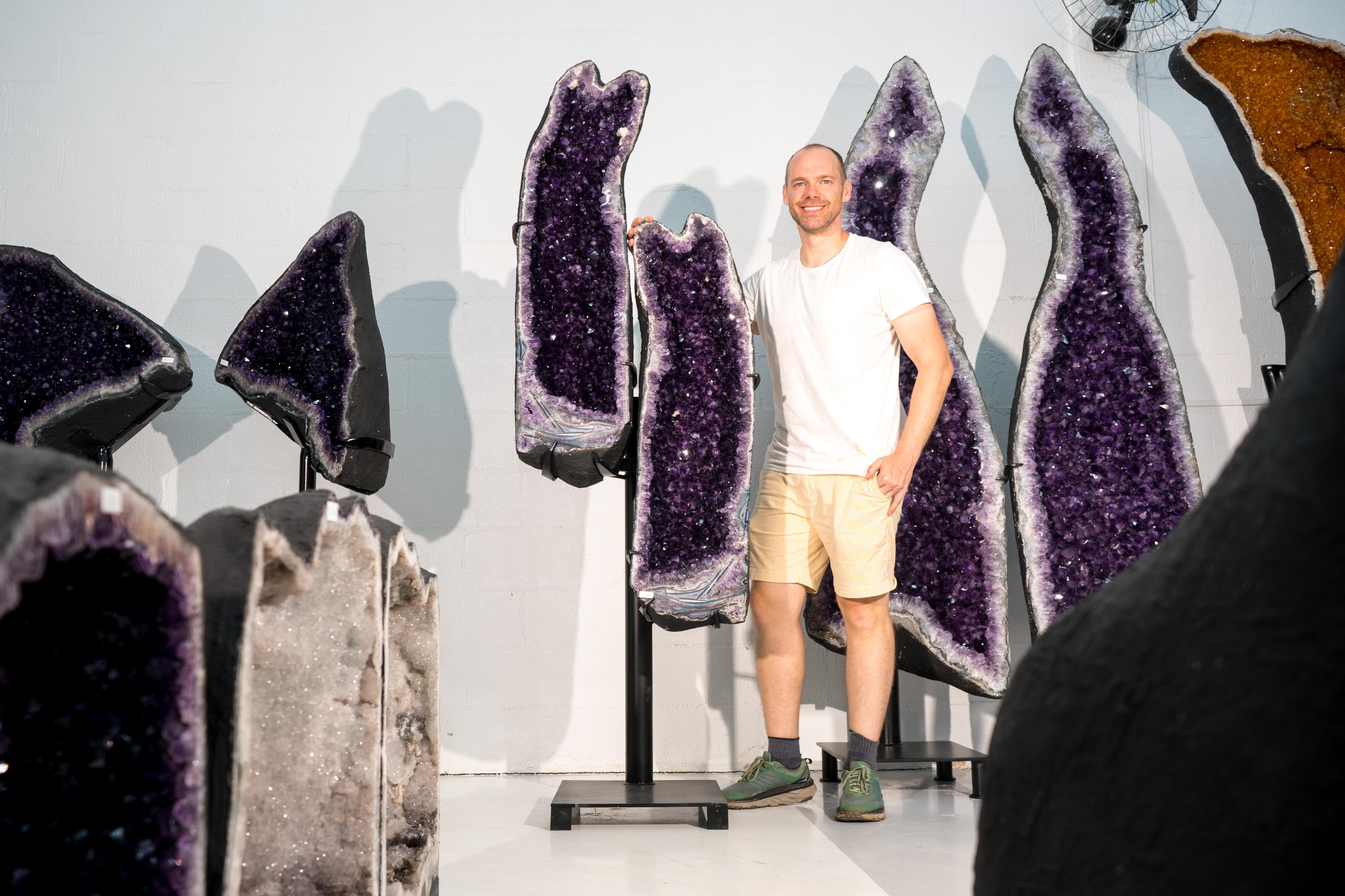 Elevate Your Space Decor and Energies with This High-Grade 6.6 Ft Amethyst Geode Pair on Custom-Made Stands

▫️ Description

This stunning sculpture combines a 100% natural, high-grade Amethyst Geode, standing tall to reveal the book-matched, unique