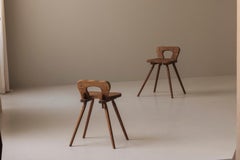 Sculptural pair of French solid oak side chairs from the 1950s