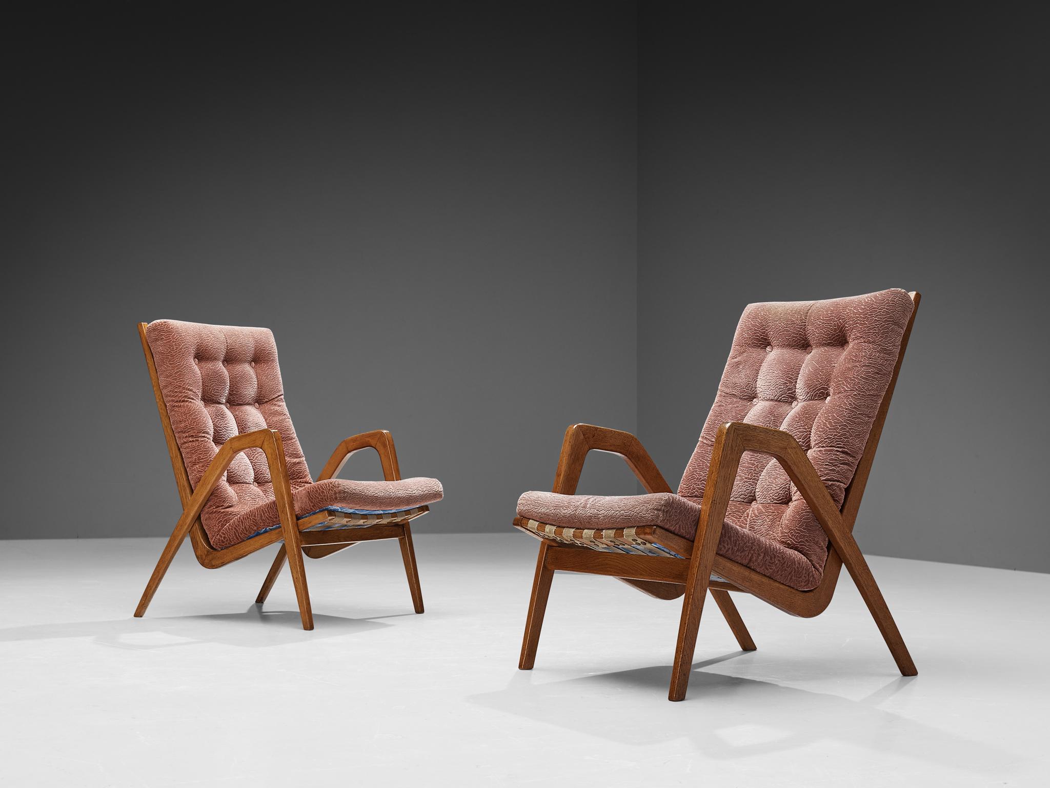 Pair of lounge chairs, oak, fabric, Europe, 1950s

Refined pair of lounge chairs that feature high backrests. The chairs are from late Art Deco period, as they show its distinctive characteristics, such as the thick tufted seat and the sculpted oak