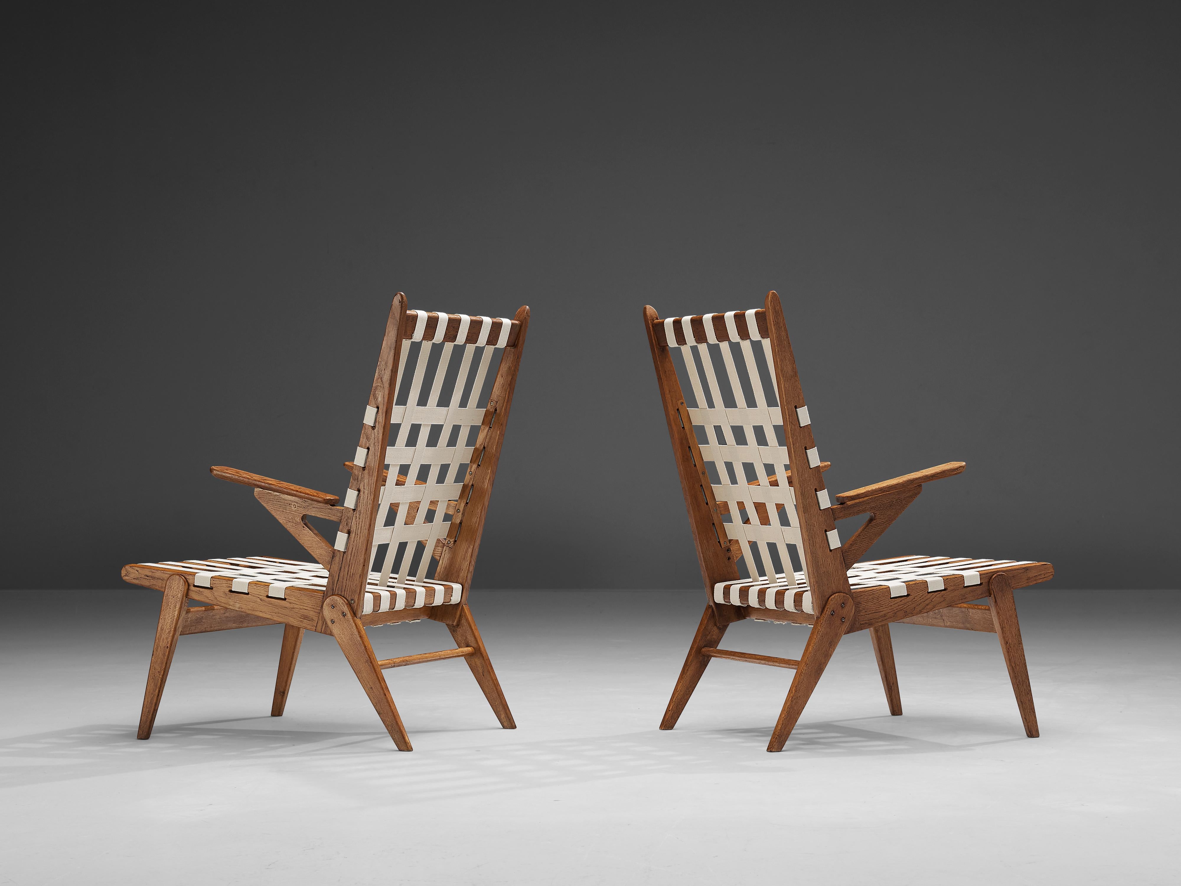 Jan Vaněk for Krásná Jizba, pair of lounge chairs, oak, canvas, metal, Czech Republic, 1940s 

These armchairs by Jan Vaněk are characterized by a construction of sharp lines and clear shapes. Multiple details, like the pointy ends of the backrest