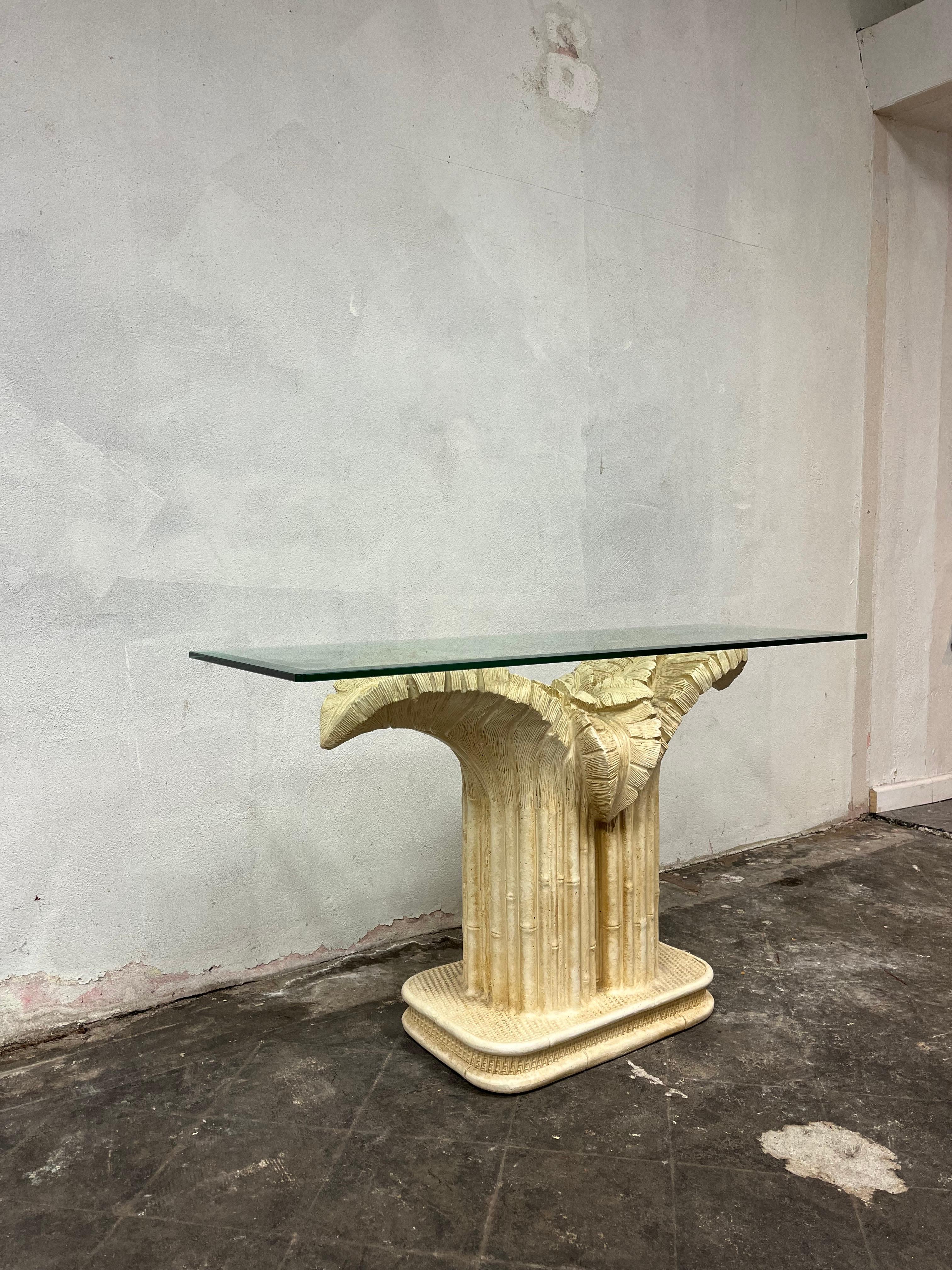 Console table sculpted in the form of large palm leaves. Based on the style of Serge Roche or Dorothy Draper. Console features dramatic tropical palm tree designed pedestal with scalloped edge glass top. Excellent condition.
Table base measures 38