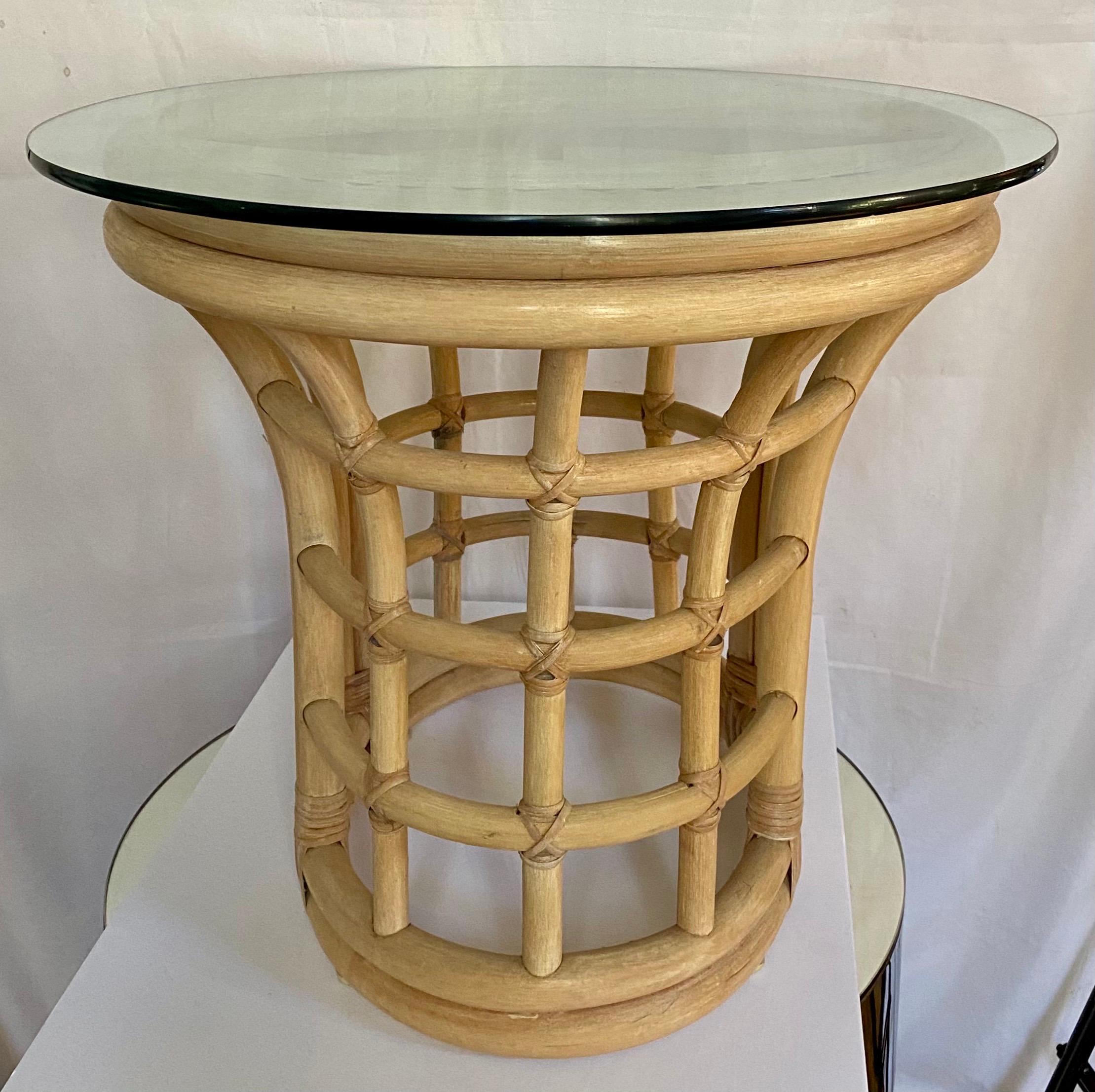 Mid-Century Modern natural rattan bamboo side table with removable clear glass top. This sculptural oval shaped table could also be used as an interesting cocktail table.