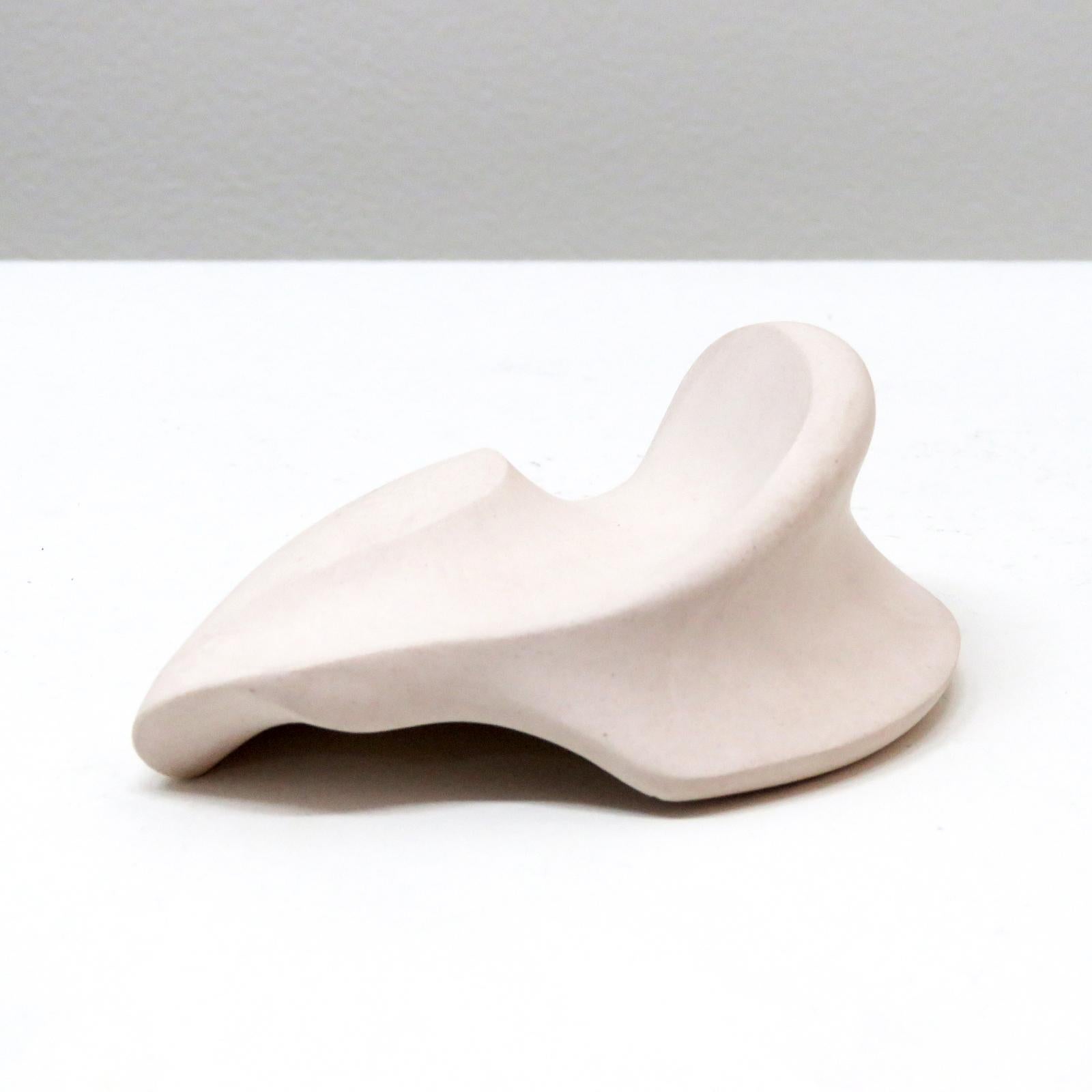 stunning palm stone titled 'ear', handcrafted by Los Angeles based ceramicist Jed Farlow. A one-of-a-kind unglazed porcelain sculpture, part of an ongoing 'Bone' series. Each of these unique pieces is meticulously crafted and meant to be hand held,